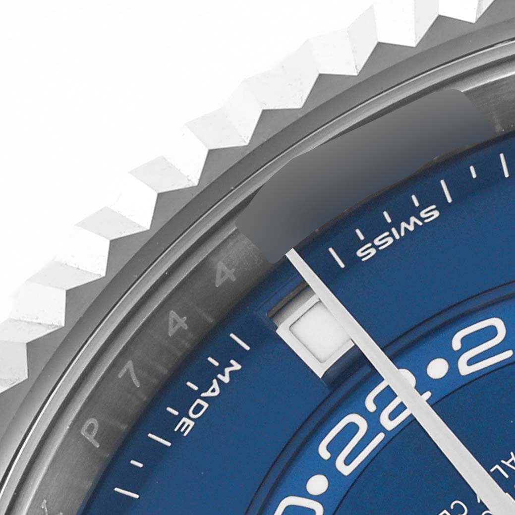 The image shows a close-up of the Rolex Sky-Dweller 326934 Men's Stainless Steel Blue Dial 326934 Men's Stainless Steel Blue Dial watch, focusing on the bezel and a portion of the blue dial.