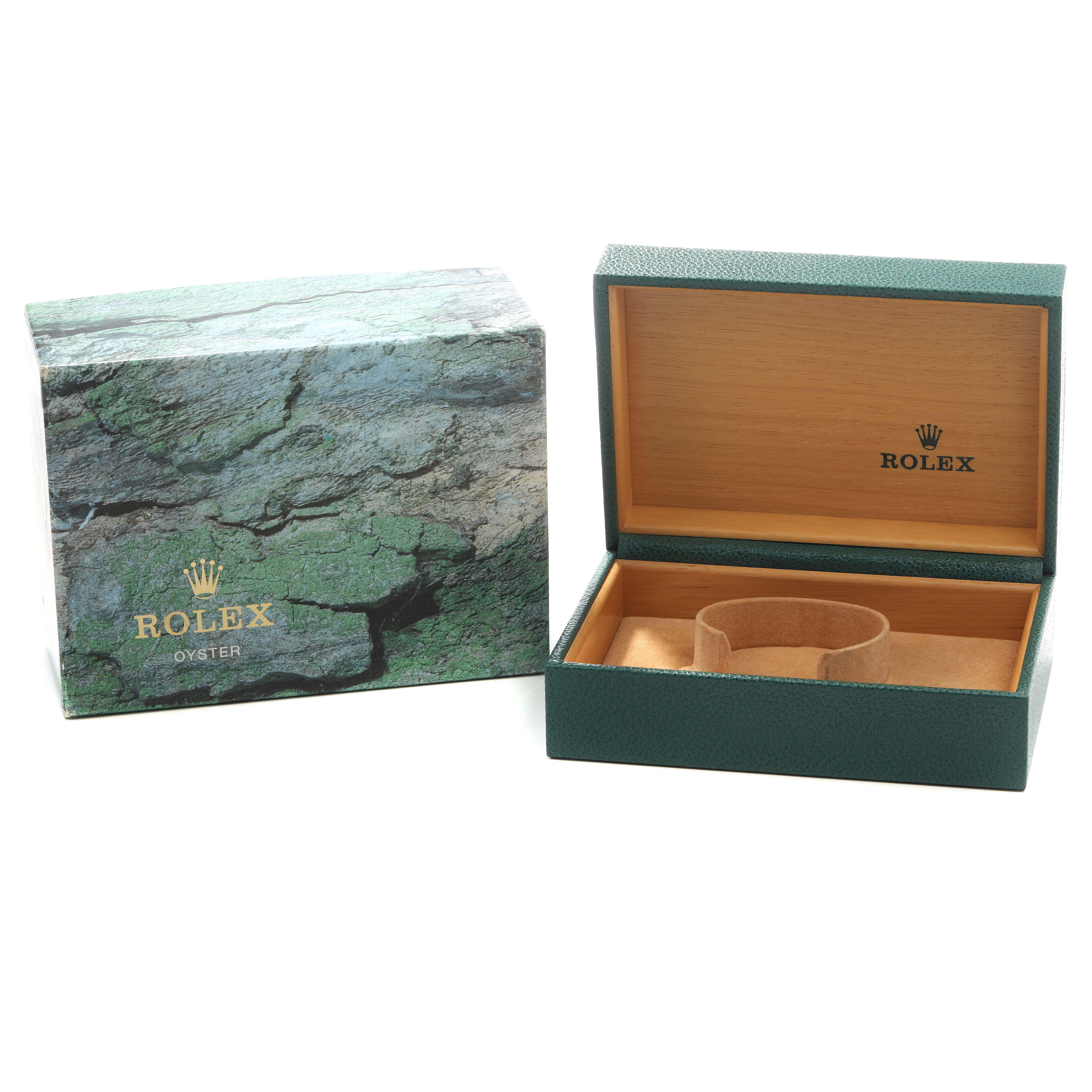 The image shows the packaging for a Rolex Submariner 16610 Men's Stainless Steel Black Dial, including a textured outer box and open display box with a cushion.