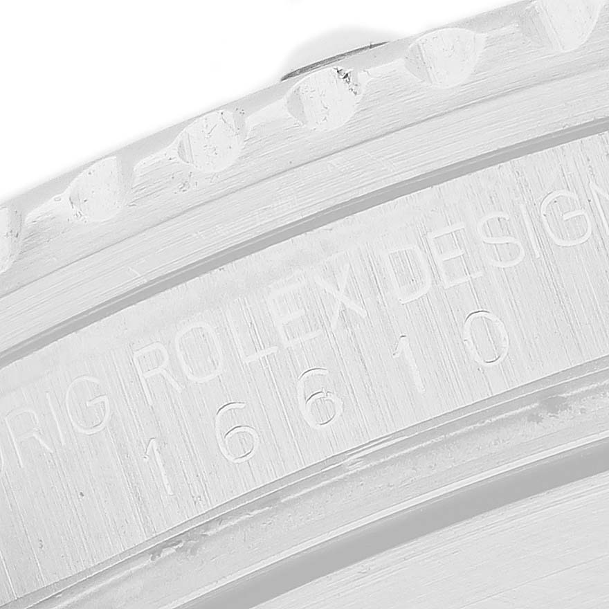 The image shows a close-up of the engraved side of the bezel and rehaut of a Rolex Submariner 16610 Men's Stainless Steel Black Dial.