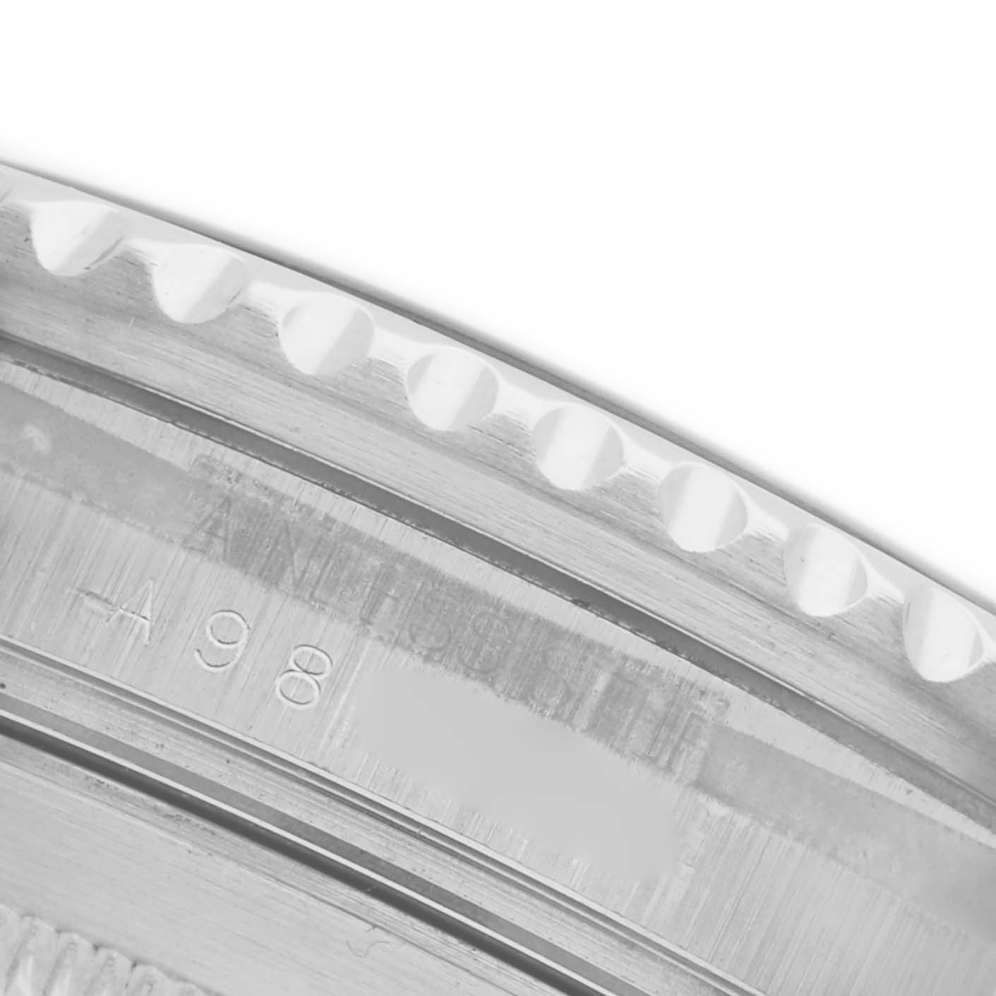 The image shows a close-up of the bezel and case edge of a Rolex Submariner 16610 Men's Stainless Steel Black Dial 16610 Men's Stainless Steel Black Dial watch, highlighting the serrated bezel and engraved details.