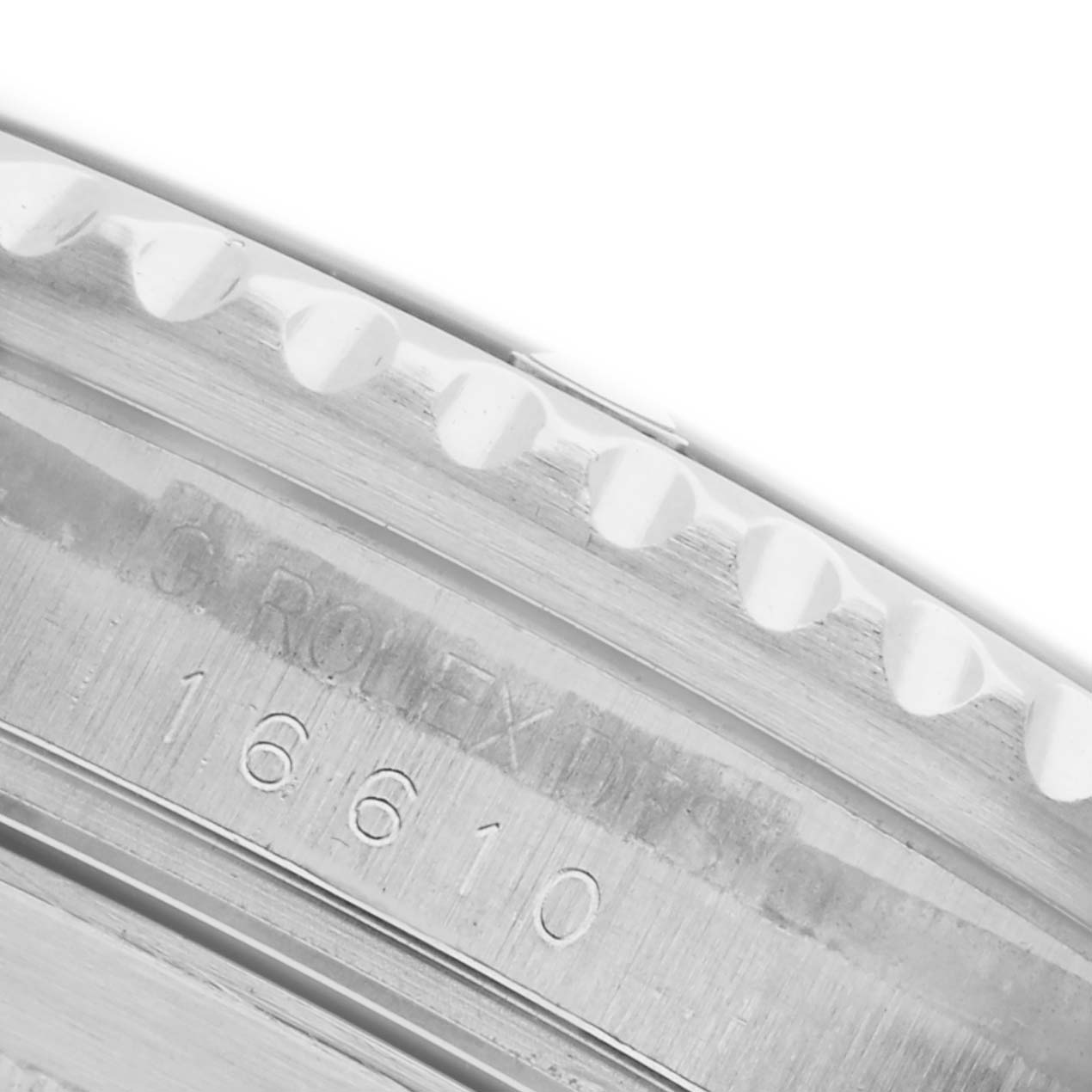 The image shows a close-up of the bezel edge and engraved model number on a Rolex Submariner 16610 Men's Stainless Steel Black Dial 16610 Men's Stainless Steel Black Dial.