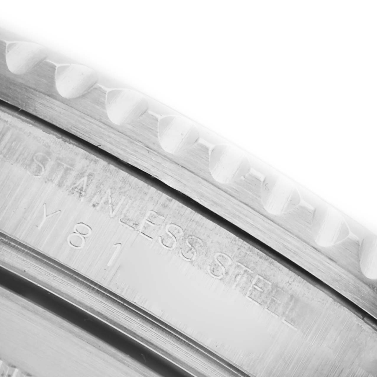 The image shows a close-up of the Rolex Submariner 16610 Men's Stainless Steel Black Dial 16610 Men's Stainless Steel Black Dial bezel and part of the case, highlighting the engraving "STAINLESS STEEL."