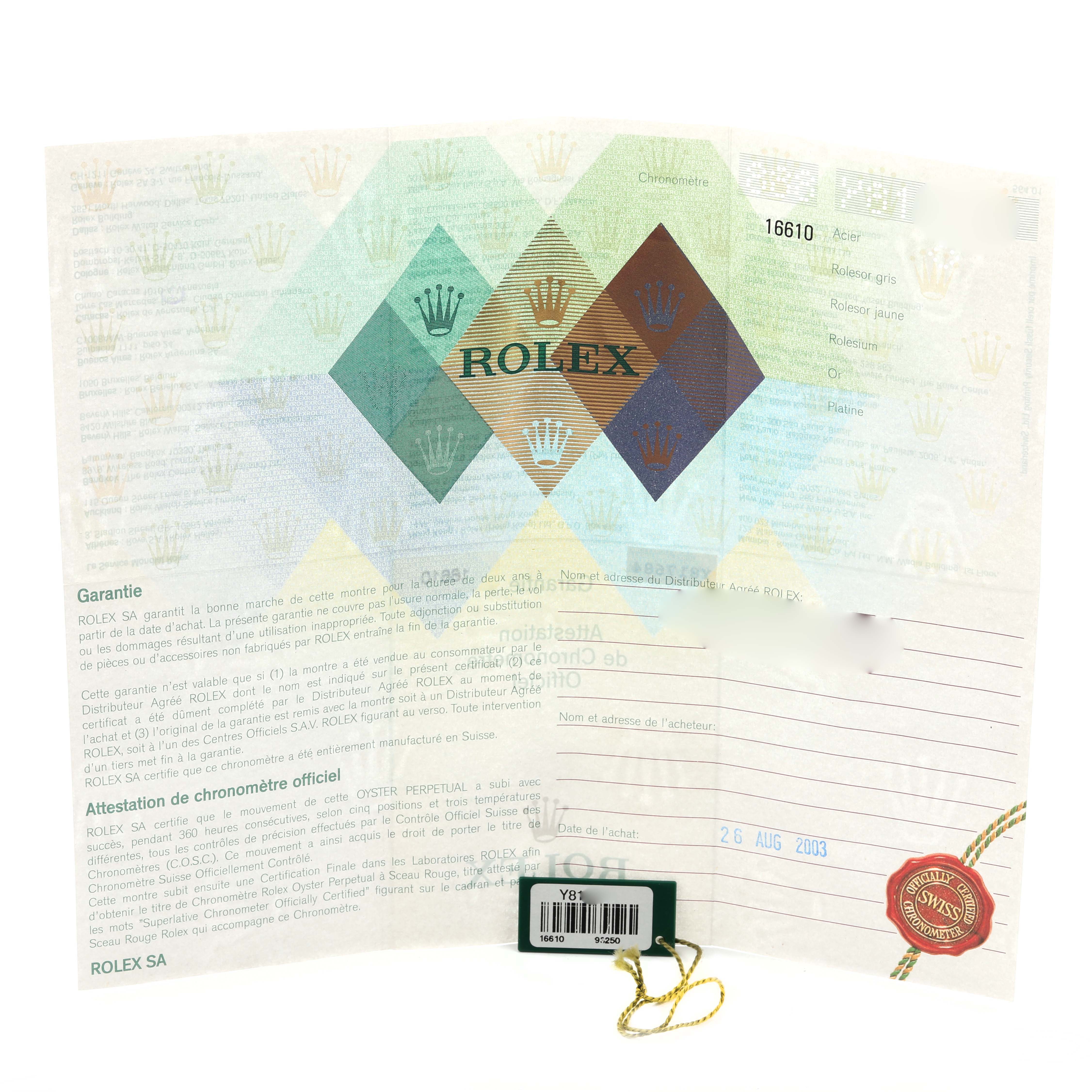 The image shows a warranty certificate and a tag for a Rolex Submariner 16610 Men's Stainless Steel Black Dial 16610 Men's Stainless Steel Black Dial, viewed from above.