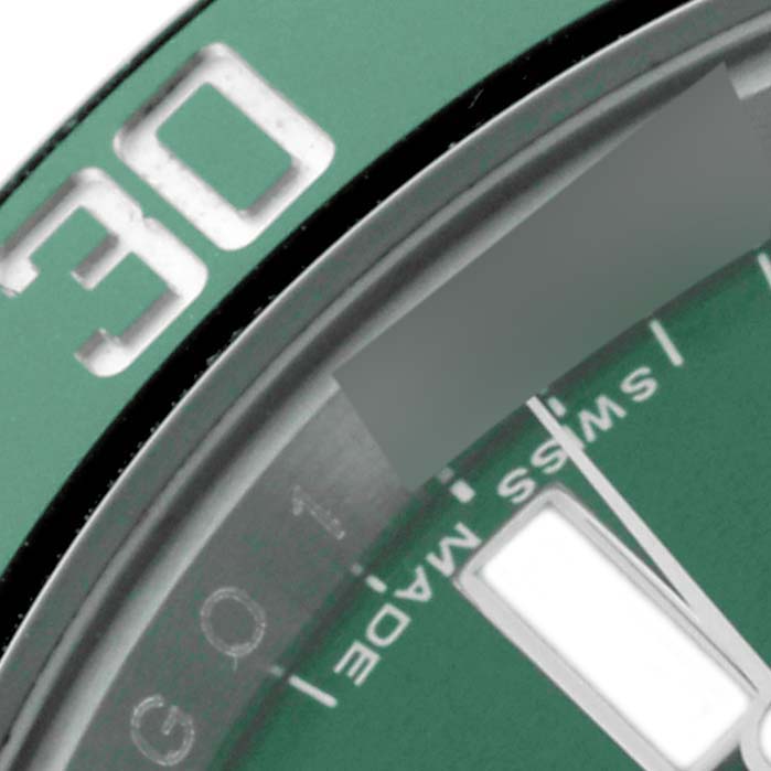 The image shows a close-up of the bezel and part of the dial of a Rolex Submariner 116610LV Men's Stainless Steel Green Dial 116610LV Men's Stainless Steel Green Dial, focusing on the 30-minute mark.