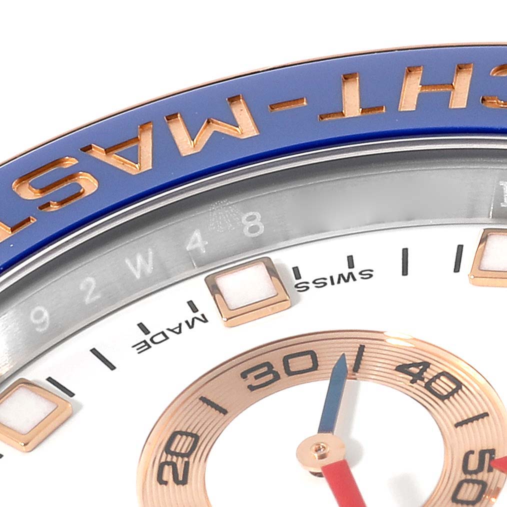 This image shows a close-up of the face and bezel of a Rolex Yacht-Master 116681 Men's Steel and Gold (two tone) White Dial 116681 Men's Steel and Gold (two tone) White Dial watch, focusing on the dial and part of the blue bezel.