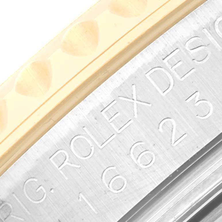 This close-up image shows the side of a Rolex Yacht-Master 16623 Men's Steel and Gold (two tone) Mother of Pearl Dial 16623 Men's Steel and Gold (two tone) Mother of Pearl Dial watch, including part of the bezel and engravings on the case.