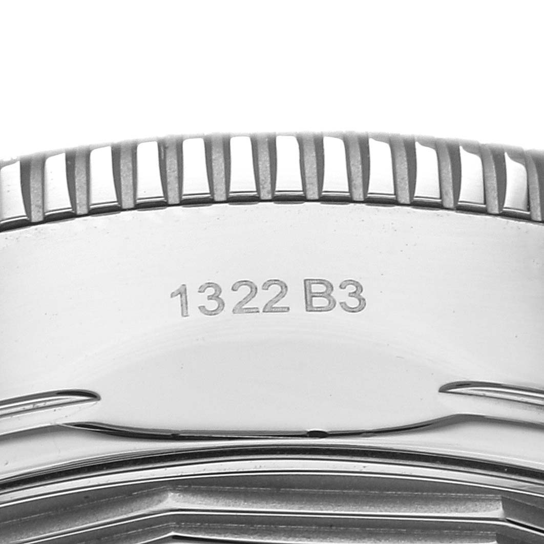 This image shows a close-up of the bezel and part of the case back of a Breitling Superocean AB2010 Men's Stainless Steel Green Dial AB2010 Men's Stainless Steel Green Dial watch with the model number 1322 B3.