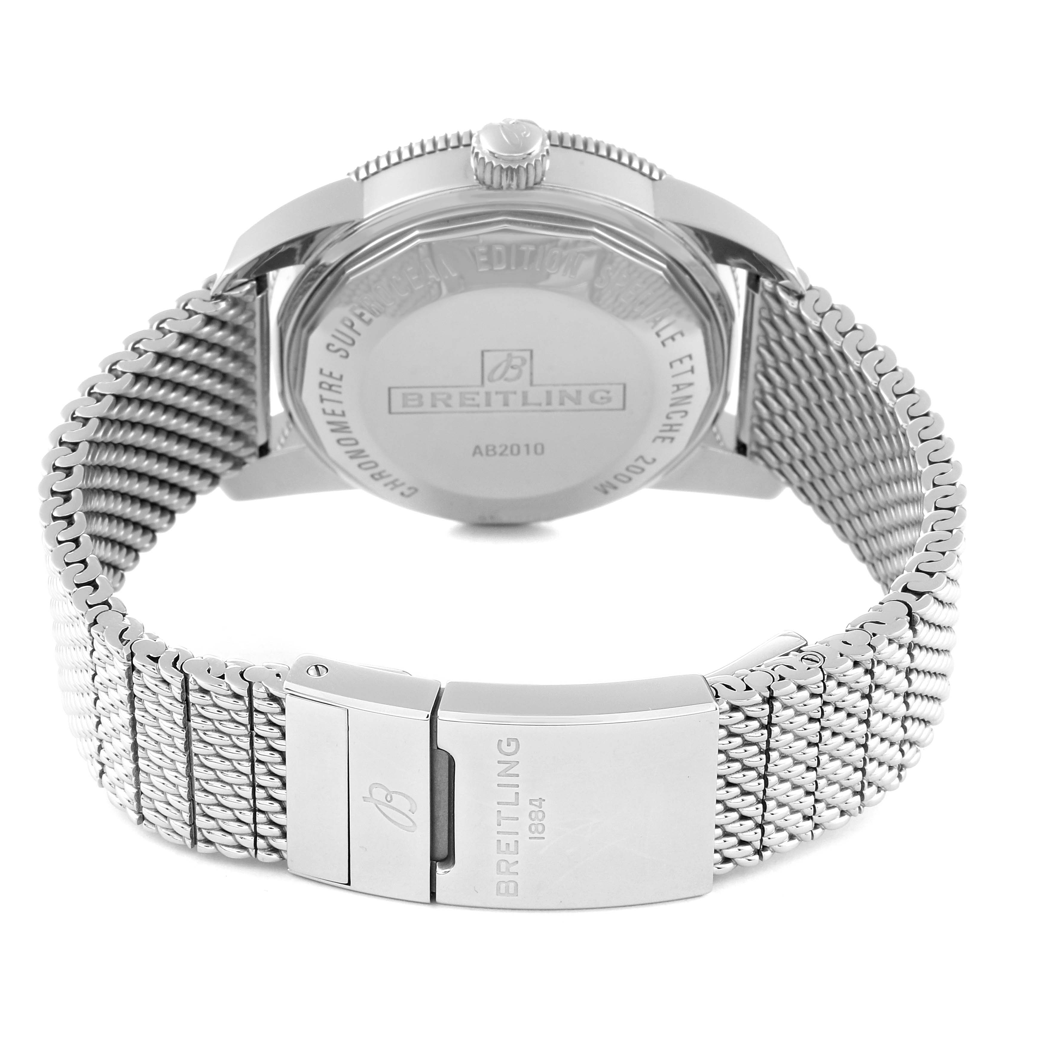 The image shows the back view of a Breitling Superocean AB2010 Men's Stainless Steel Green Dial AB2010 Men's Stainless Steel Green Dial watch, featuring its case back, crown, and metal mesh strap with the clasp.