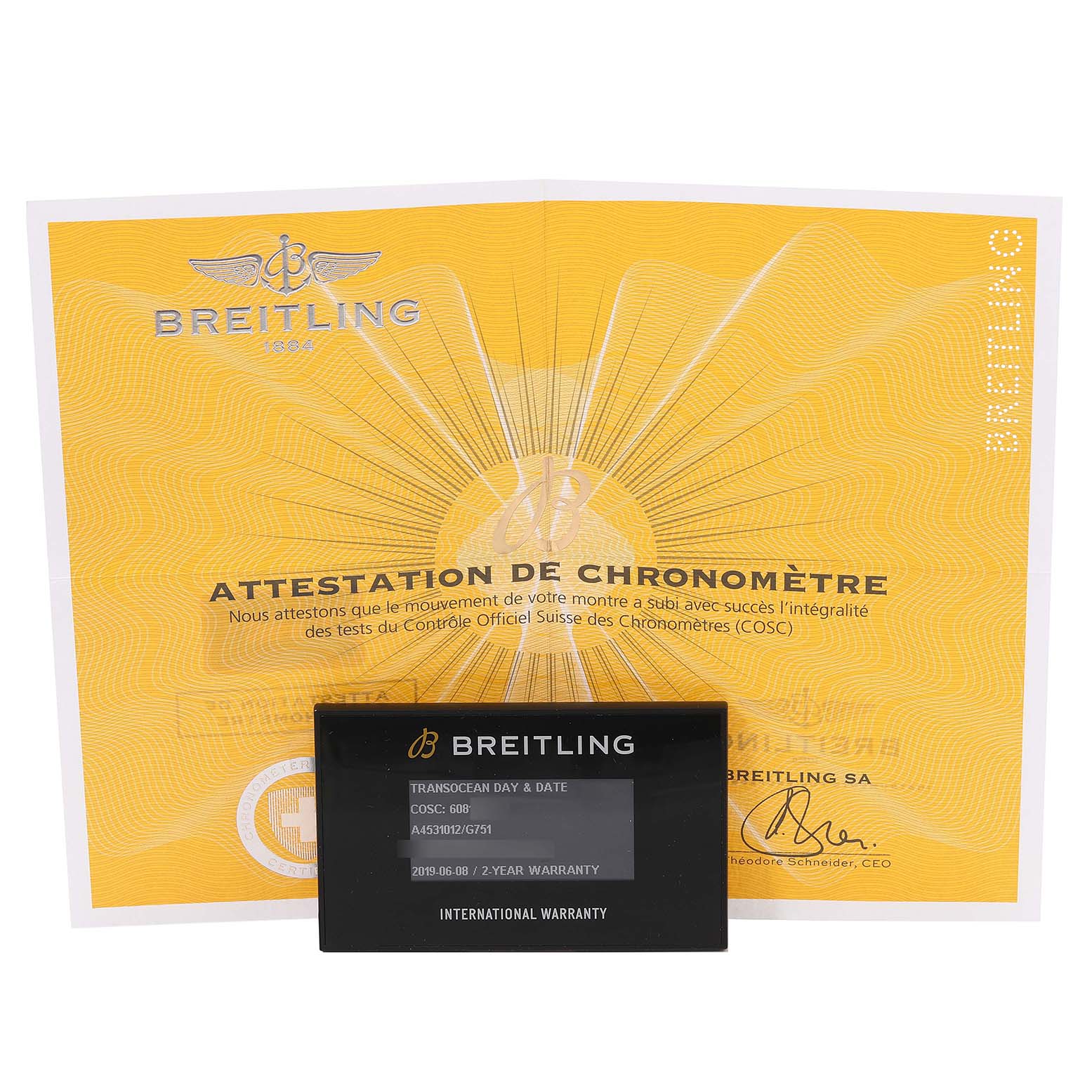 The image shows a Breitling Transocean A45310 Men's Stainless Steel Silver Dial A45310 Men's Stainless Steel Silver Dial model's international warranty card and chronometer certificate from a front angle.