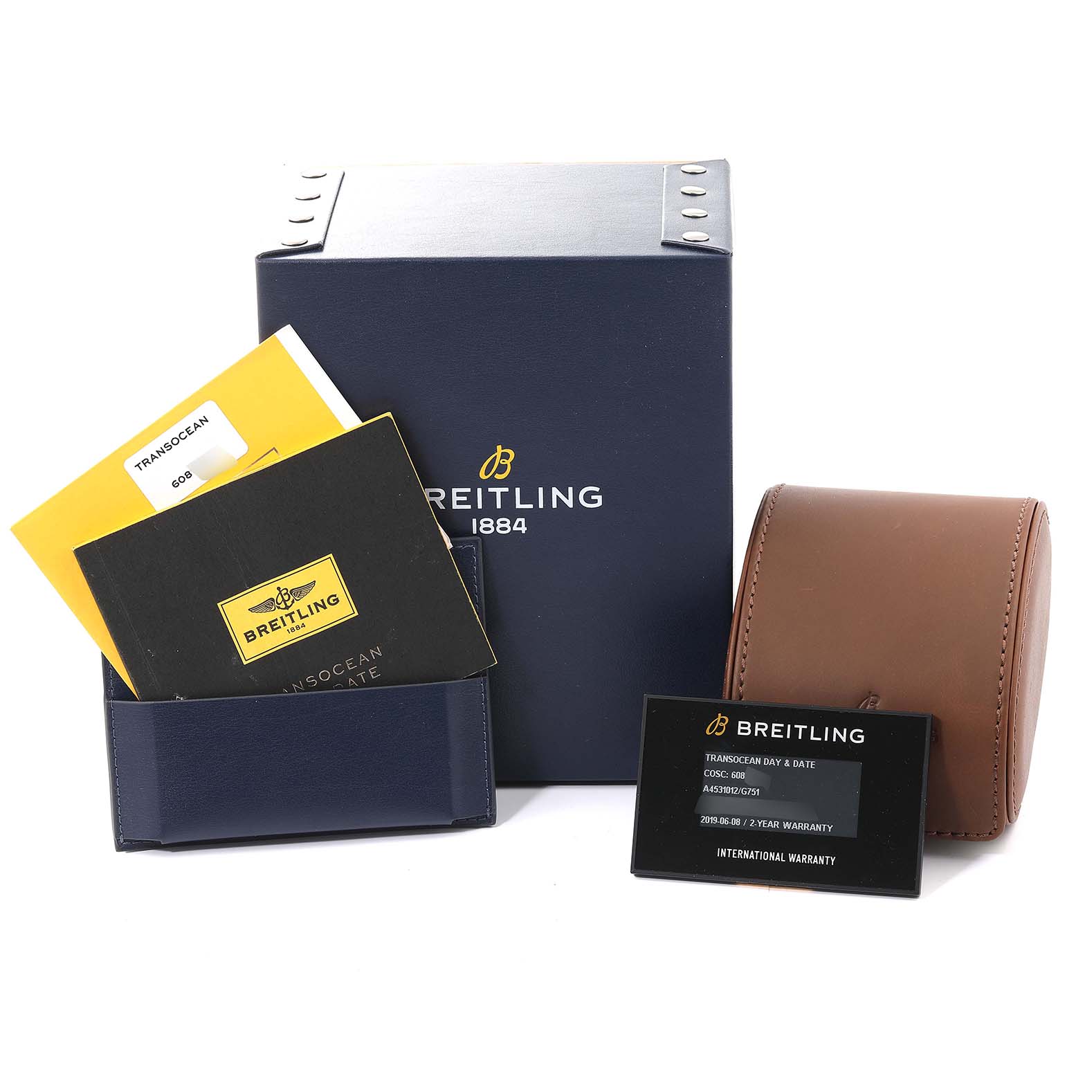 The image shows the packaging, manuals, warranty card, and a watch case for the Breitling Transocean A45310 Men's Stainless Steel Silver Dial A45310 Men's Stainless Steel Silver Dial model.