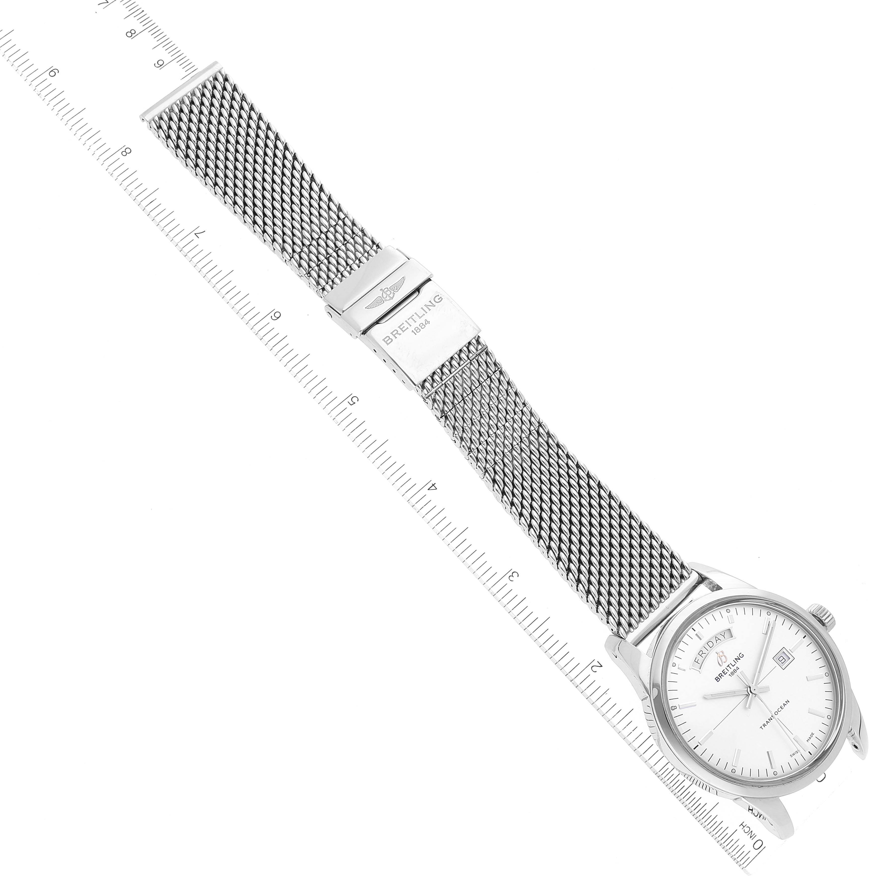 The Breitling Transocean A45310 Men's Stainless Steel Silver Dial A45310 Men's Stainless Steel Silver Dial watch is shown at a slight angle, displaying its face and mesh band alongside a ruler for scale.
