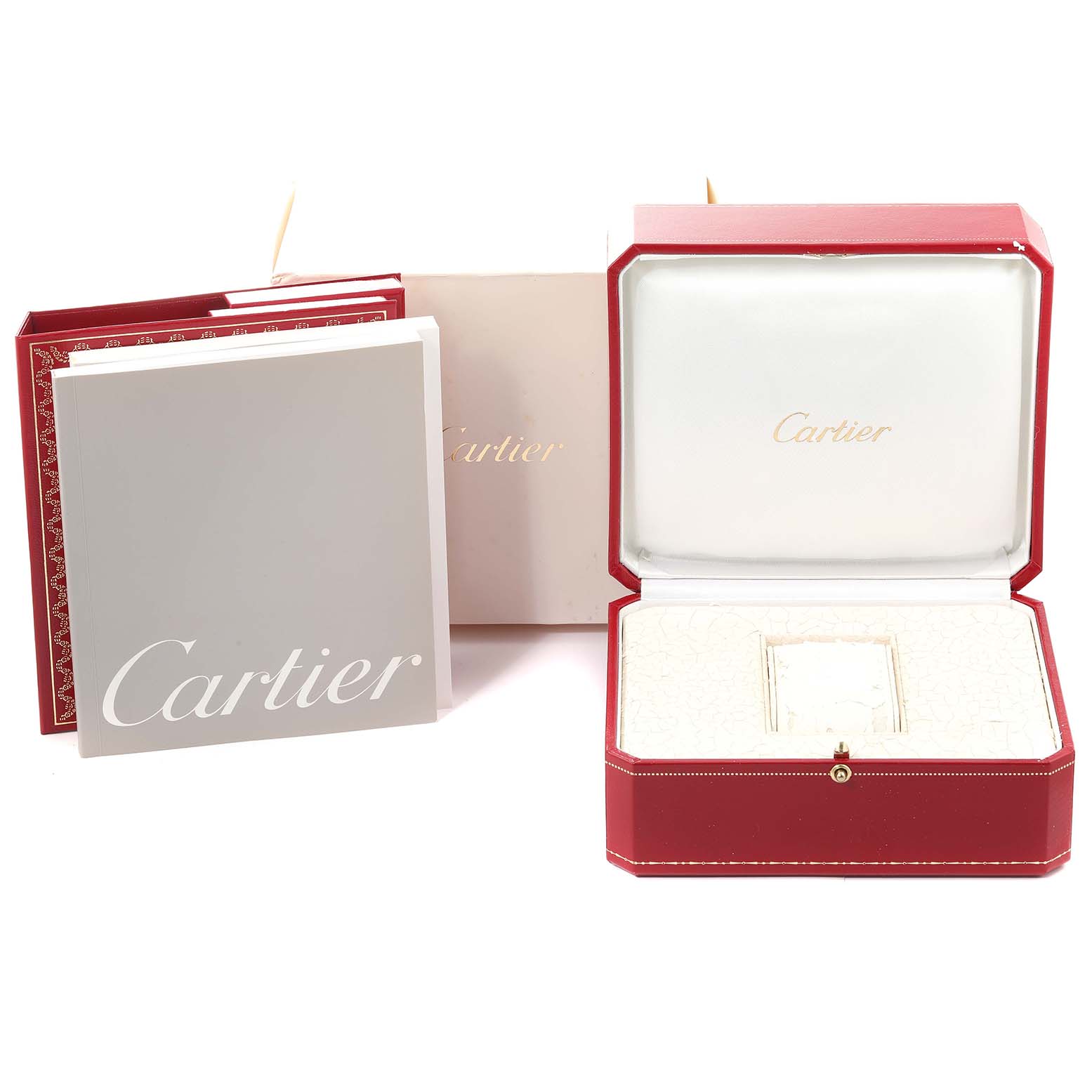 The image shows the Cartier Tank Française's packaging, including the watch box, manuals, and a paper bag.