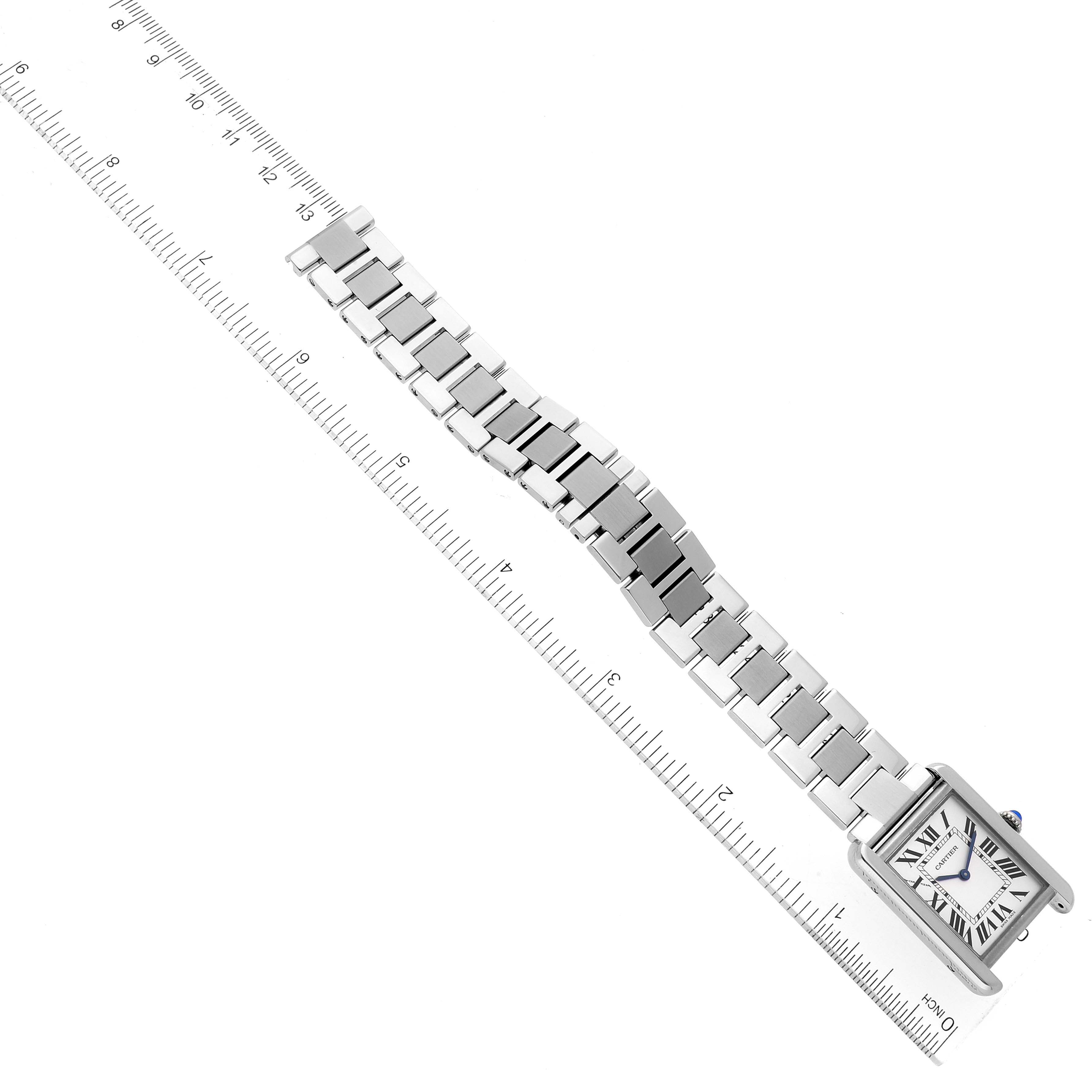 This image shows a complete side view of the Cartier Tank Solo W5200013 Women's Stainless Steel Silver Dial W5200013 Women's Stainless Steel Silver Dial watch, including its face and metal bracelet, against a measuring ruler.