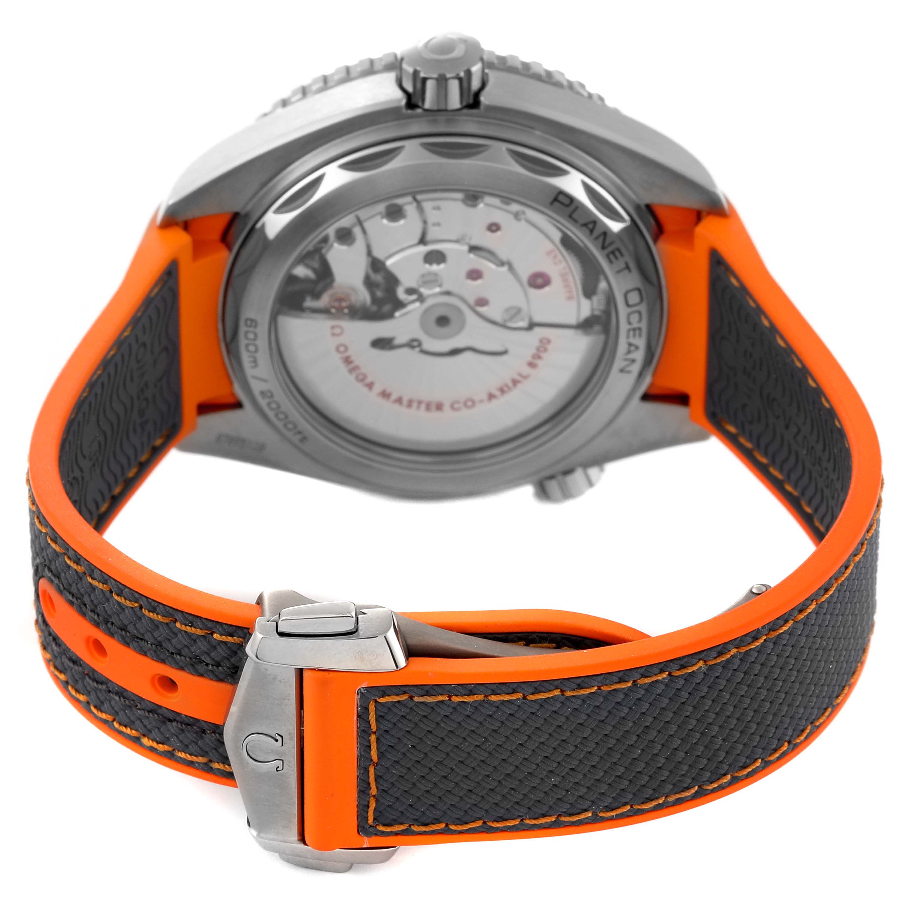 The image shows the back view of the Omega Planet Ocean 215.92.44.21.99.001 Men's Titanium Grey Dial 215.92.44.21.99.001 Men's Titanium Grey Dial watch, highlighting its transparent case back, rotor, and orange-black strap.