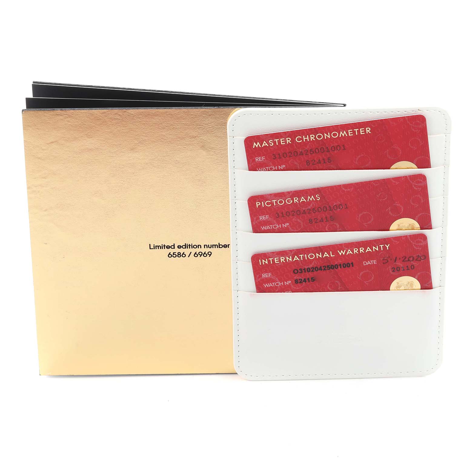 The image shows warranty cards and certification documents for the Omega Speedmaster 310.20.42.50.01.001 Men's Stainless Steel Grey Dial 310.20.42.50.01.001 Men's Stainless Steel Grey Dial watch.