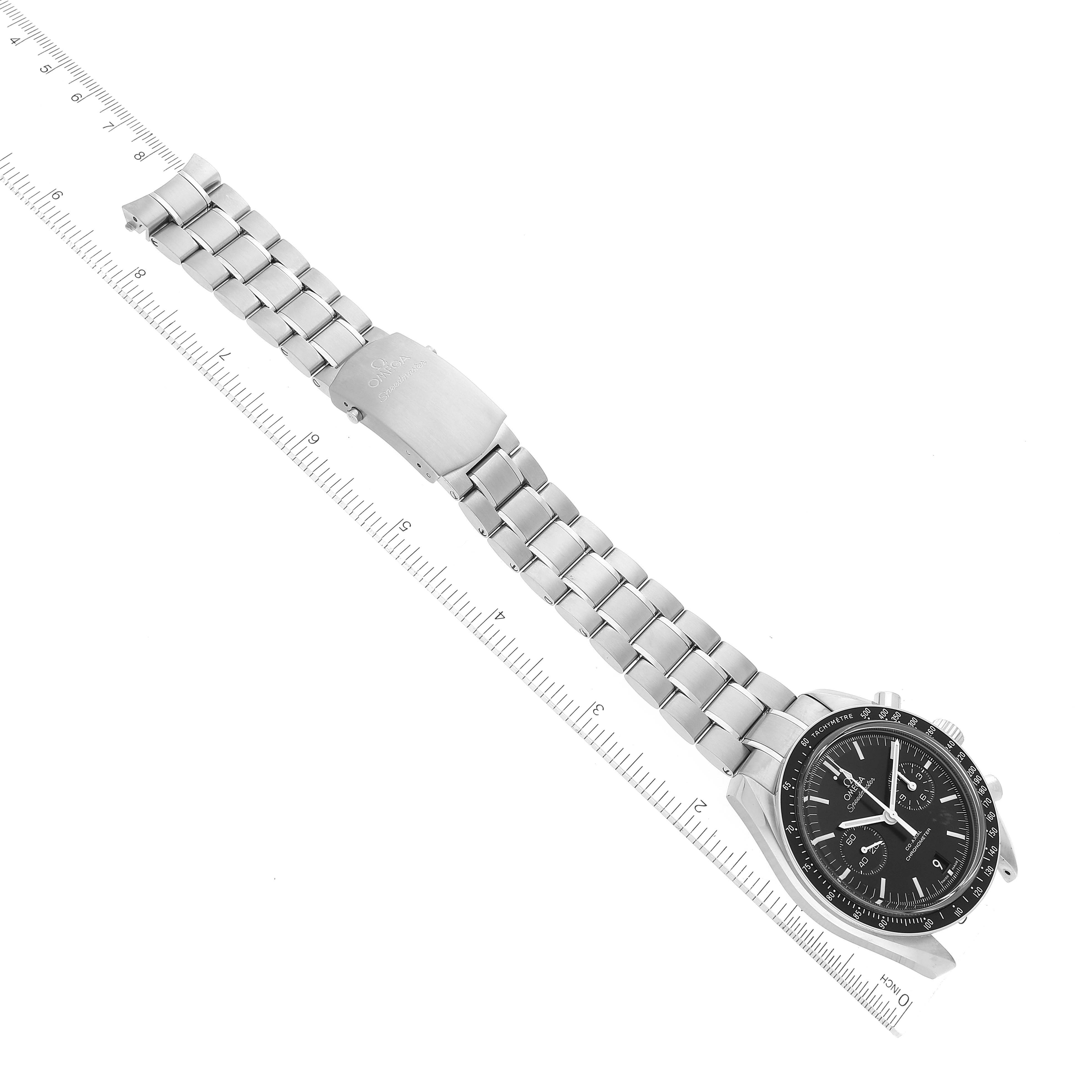 A top-down view of the Omega Speedmaster 311.30.44.51.01.002 Men's Stainless Steel Black Dial 311.30.44.51.01.002 Men's Stainless Steel Black Dial watch showing the full bracelet, clasp, and face next to a measuring scale.