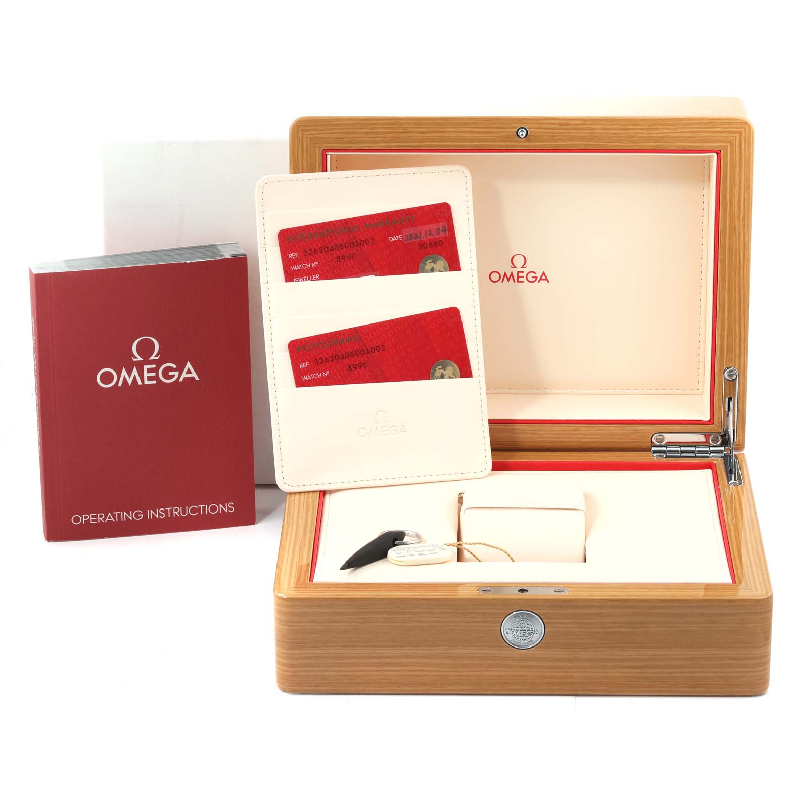 This image shows the box, warranty cards, and operating instructions for the Omega Speedmaster 326.30.40.50.01.002 Men's Stainless Steel Black Dial 326.30.40.50.01.002 Men's Stainless Steel Black Dial watch.