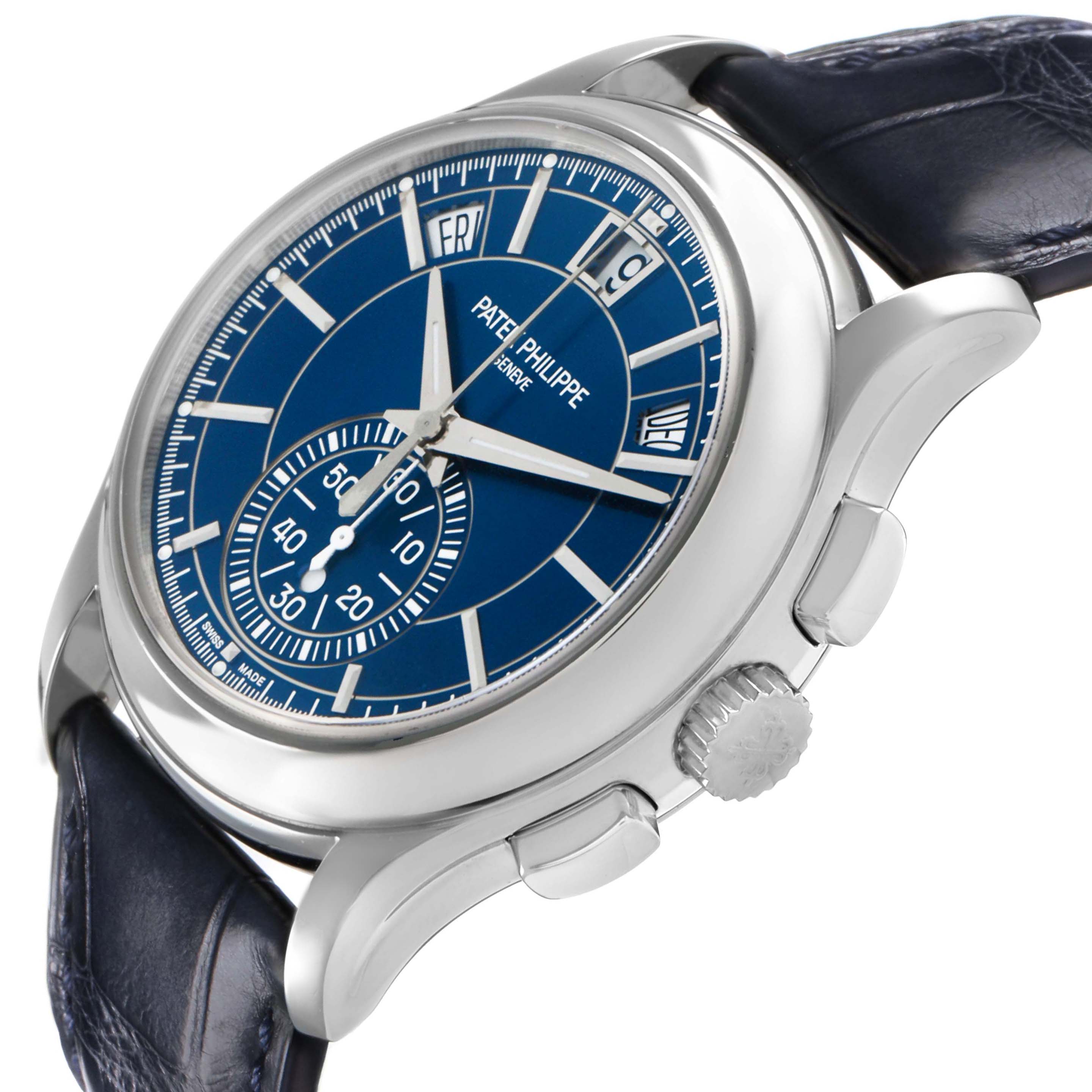 The Patek Philippe Complications 5905P - 001 Men's Platinum Blue Dial model is shown at an angle, highlighting the dial, crown, and lugs with a blue strap.