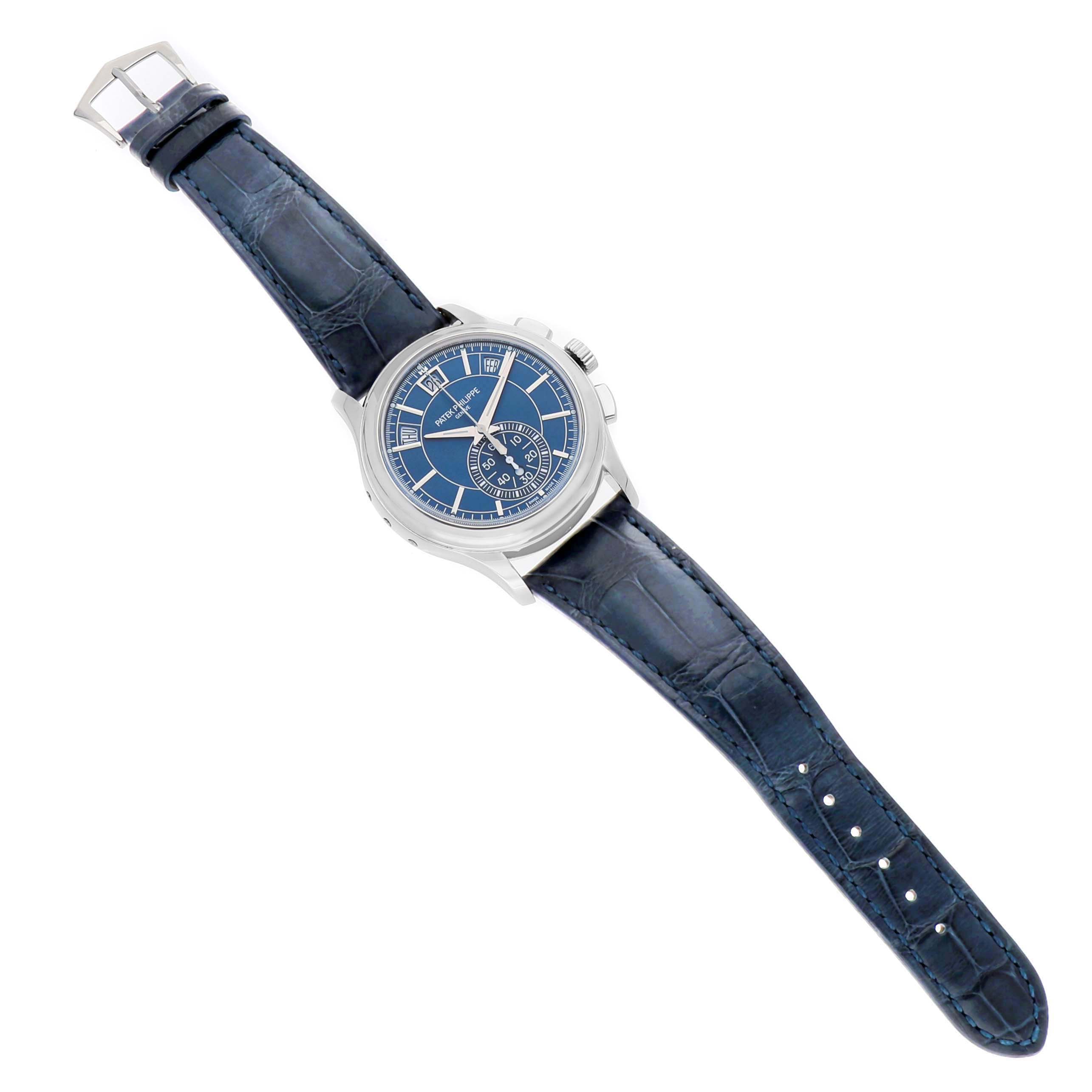 The Patek Philippe Complications 5905P - 001 Men's Platinum Blue Dial watch is shown from a top-down angle, displaying its blue dial, case, and dark leather strap.