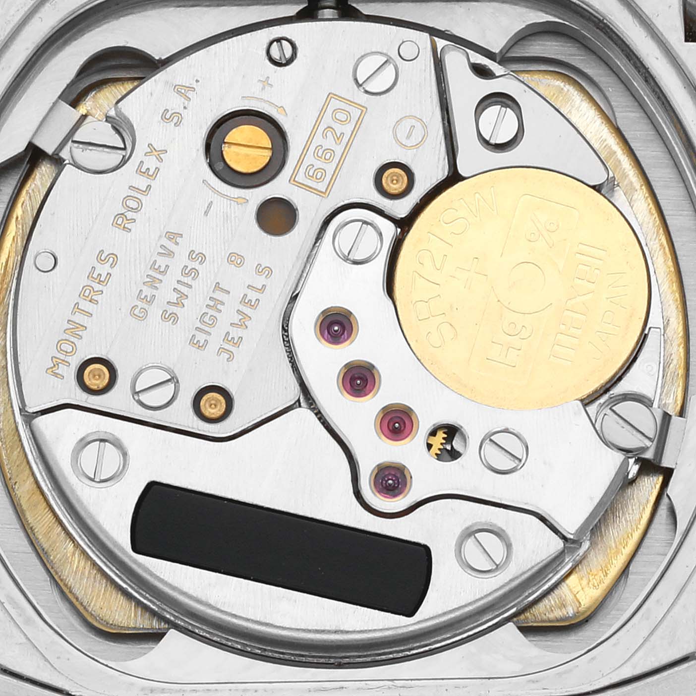 The image shows a close-up view of the movement mechanism of a Rolex Cellini 6631/9 Women's White Gold Pink Dial 6631/9 Women's White Gold Pink Dial watch, highlighting components such as jewels and a battery.