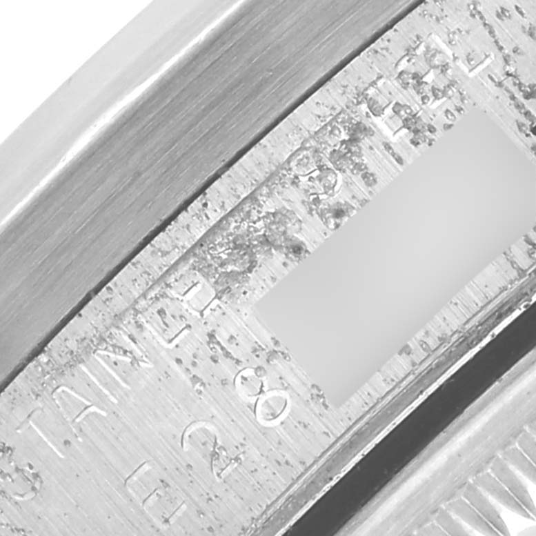 The image shows a close-up of the engraved part of a Rolex Date 15210 Men's Stainless Steel White Dial 15210 Men's Stainless Steel White Dial watch, focusing on the inner bezel and inscriptions.