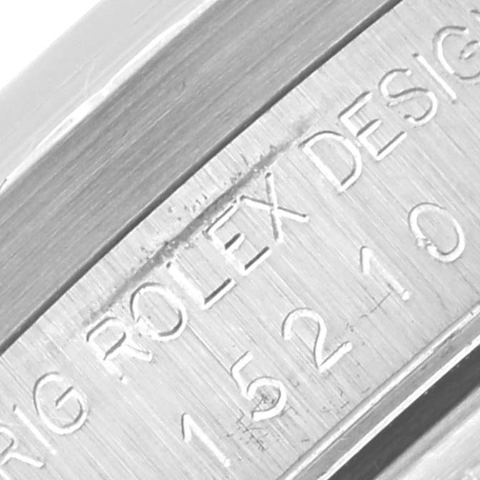 The image shows a close-up of the engraved side of a Rolex Date 15210 Men's Stainless Steel White Dial 15210 Men's Stainless Steel White Dial model watch, highlighting its reference number and design.