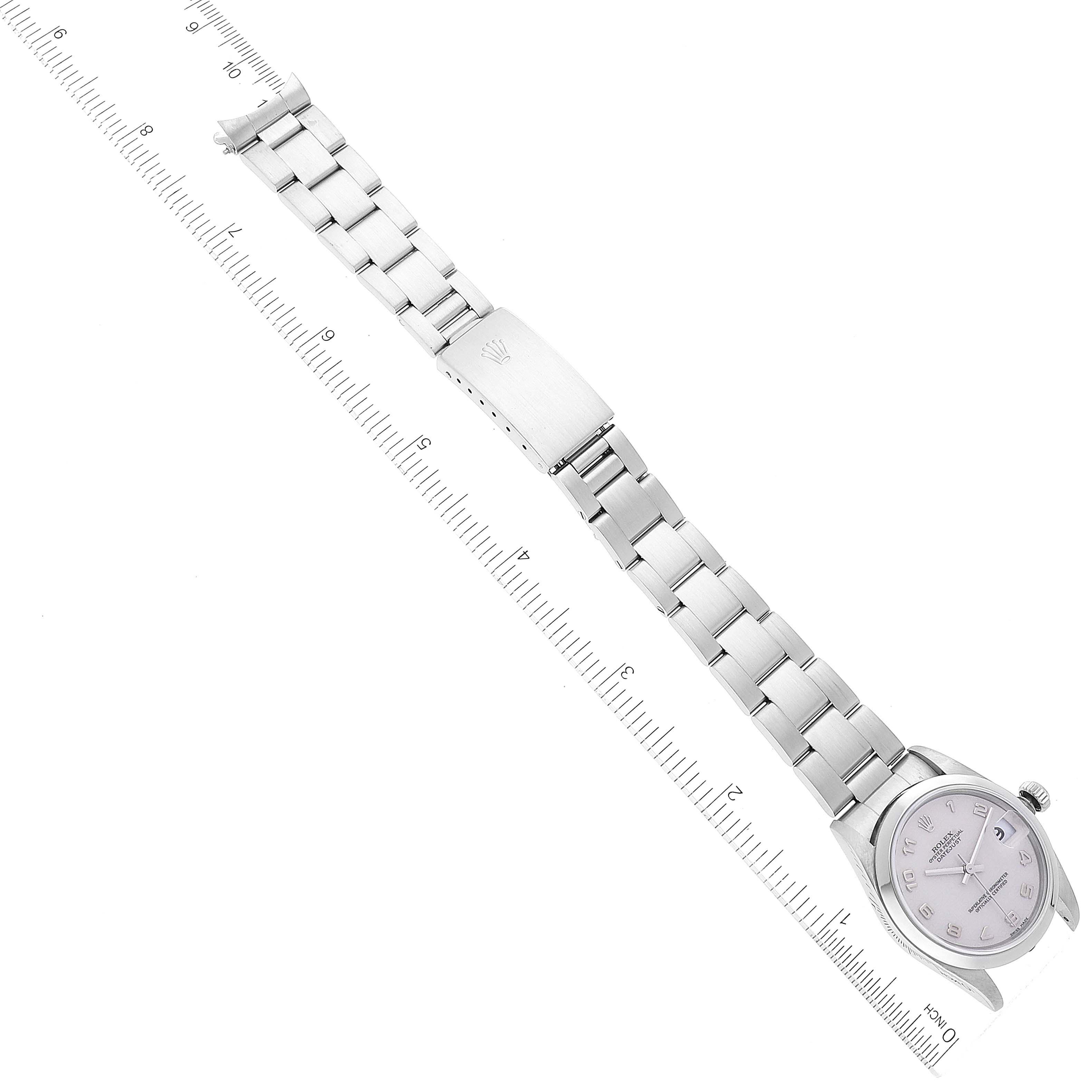 The image shows a Rolex Mid-Size 78240 Women's Stainless Steel Silver Dial 78240 Women's Stainless Steel Silver Dial model watch laid flat, highlighting its band, clasp, and face against a measuring ruler.