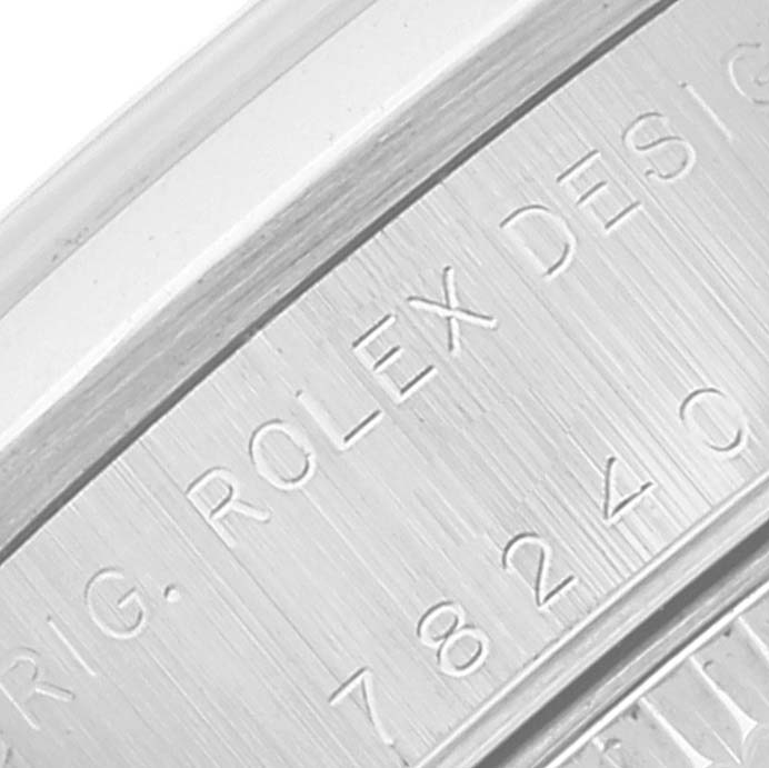 This close-up image shows the side inscription on the case back of a Mid-Size Rolex watch.