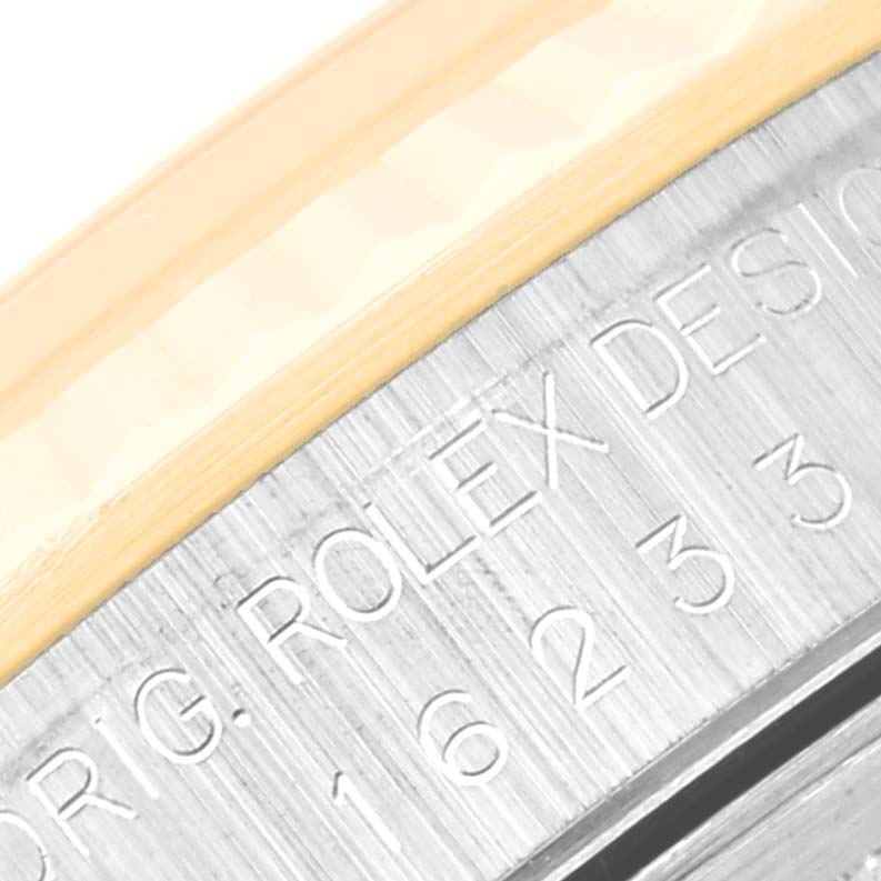 This close-up view shows the engraved details on the case side of a Rolex Datejust 16233 Men's Steel and Gold (two tone) Champagne Dial 16233 Men's Steel and Gold (two tone) Champagne Dial watch.