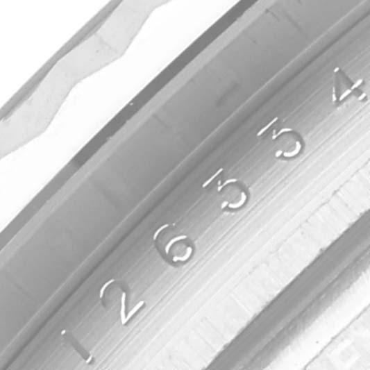 The image shows a partial side view of the bezel and fluted detailing of a Rolex Datejust 41 126334 Men
s Stainless Steel Silver Dial 126334 Men
s Stainless Steel Silver Dial watch.