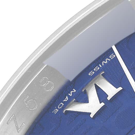 The image shows an angled close-up of the bezel and part of the dial of a Rolex Datejust 116200 Men's Stainless Steel Blue Dial 116200 Men's Stainless Steel Blue Dial watch.