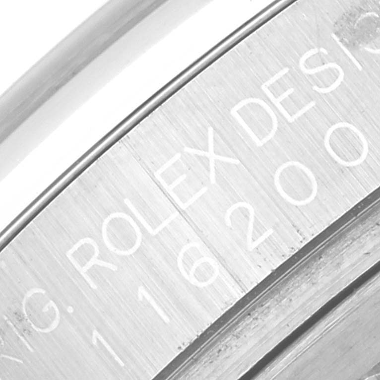This image shows a close-up of the engraved text on the inner bezel of a Rolex Datejust 116200 Men's Stainless Steel Blue Dial 116200 Men's Stainless Steel Blue Dial watch.