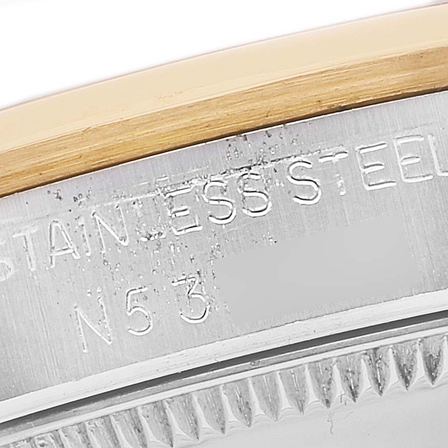 The image shows a close-up of the stainless steel case and part of the bezel of a Mid-Size Rolex watch.