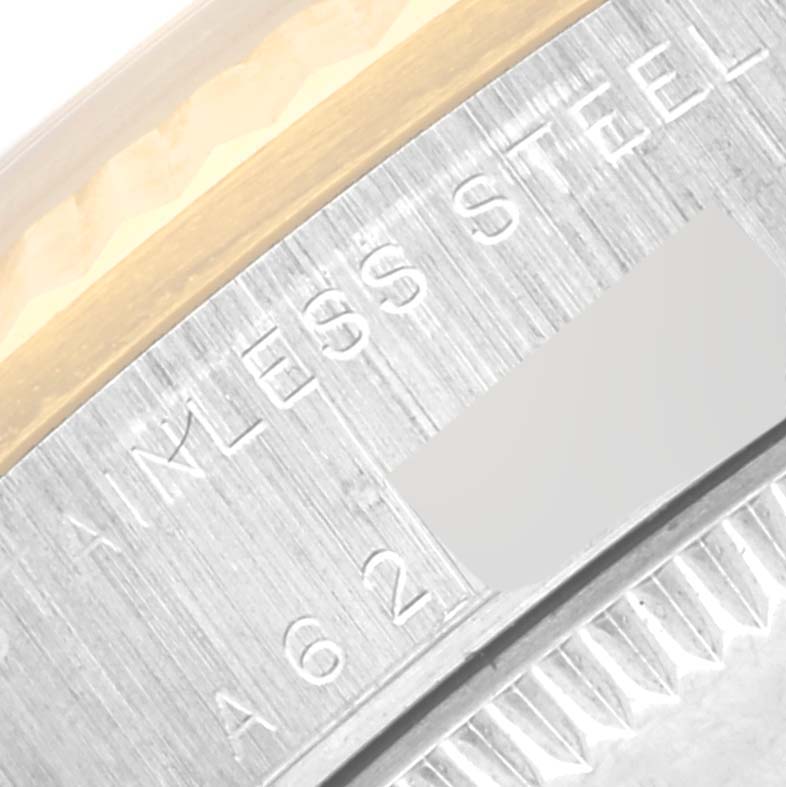 The image shows a close-up of the engraved bezel and caseback edge of a Rolex Mid-Size 78273 Women's Steel and Gold (two tone) Black Dial 78273 Women's Steel and Gold (two tone) Black Dial model watch, highlighting the "STAINLESS STEEL" text.