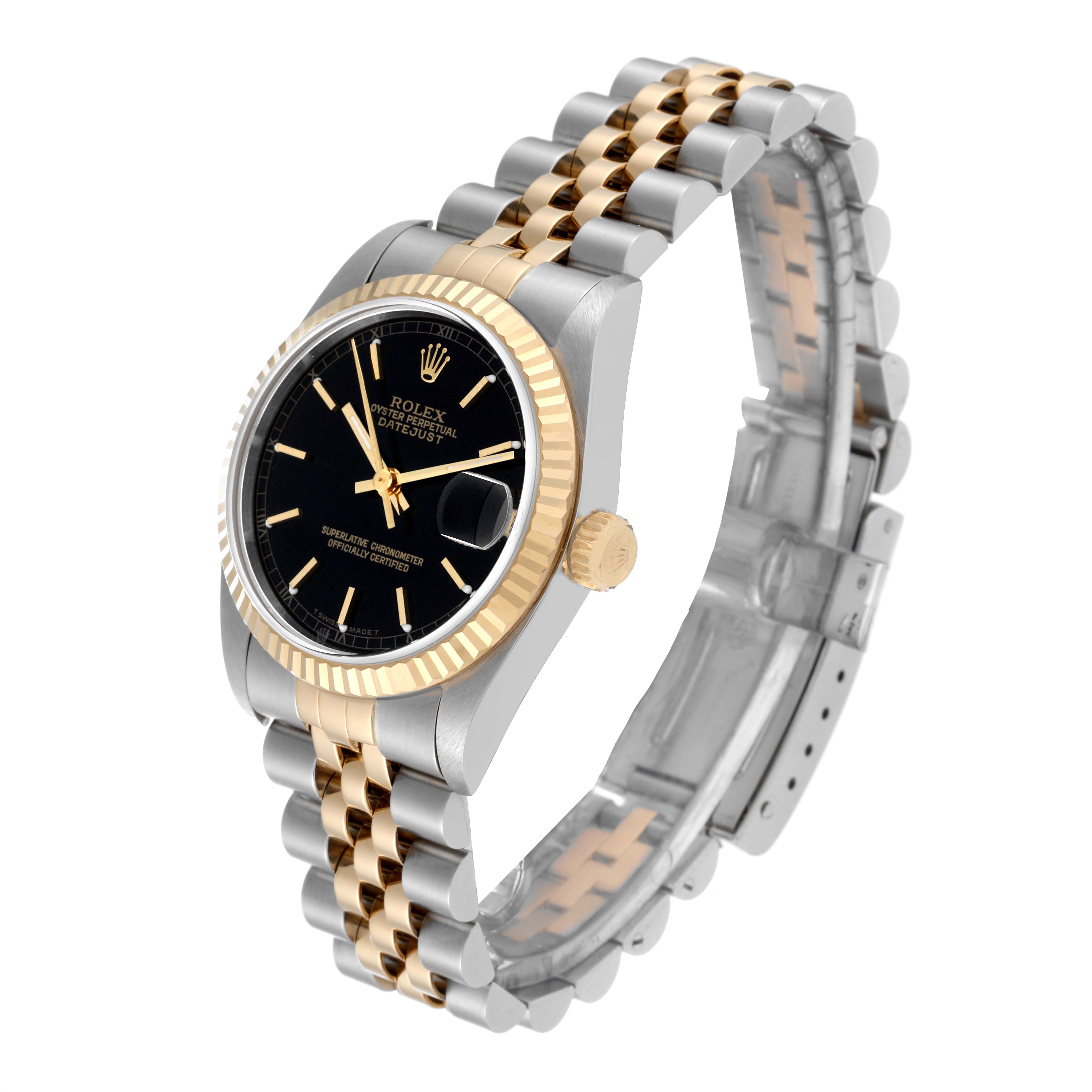 The Mid-Size Rolex watch is shown at a slight angle, highlighting its two-tone bracelet, black dial, and fluted bezel.