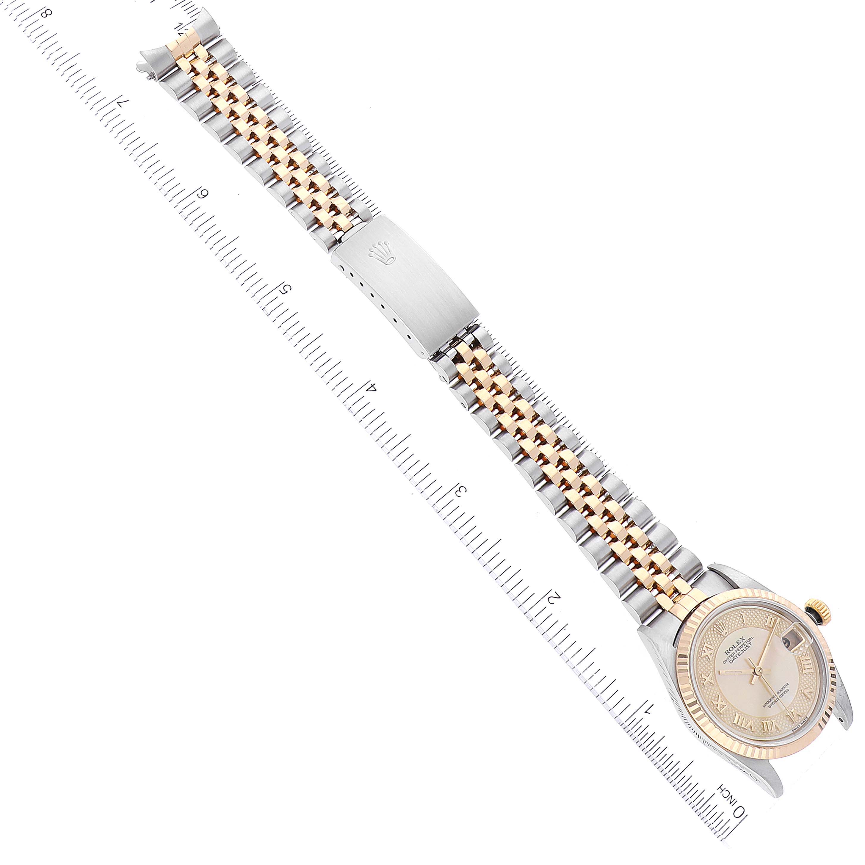 The image shows a full view of a Mid-Size Rolex watch, including the face, bezel, and bracelet, from a top-down angle.