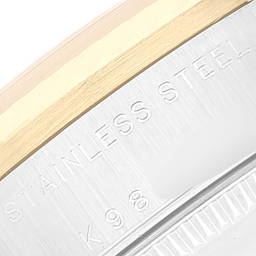 This image shows a close-up of the stainless steel back and gold edge of a Mid-Size Rolex watch.