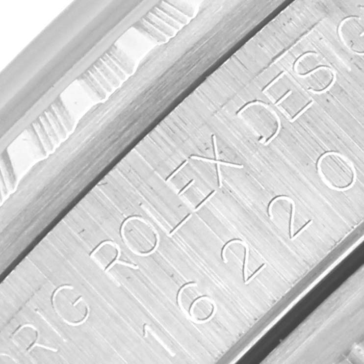 The image shows a close-up of the engraved rehaut and bezel area of a Rolex Datejust 16220 Men's Stainless Steel Silver Dial 16220 Men's Stainless Steel Silver Dial watch.
