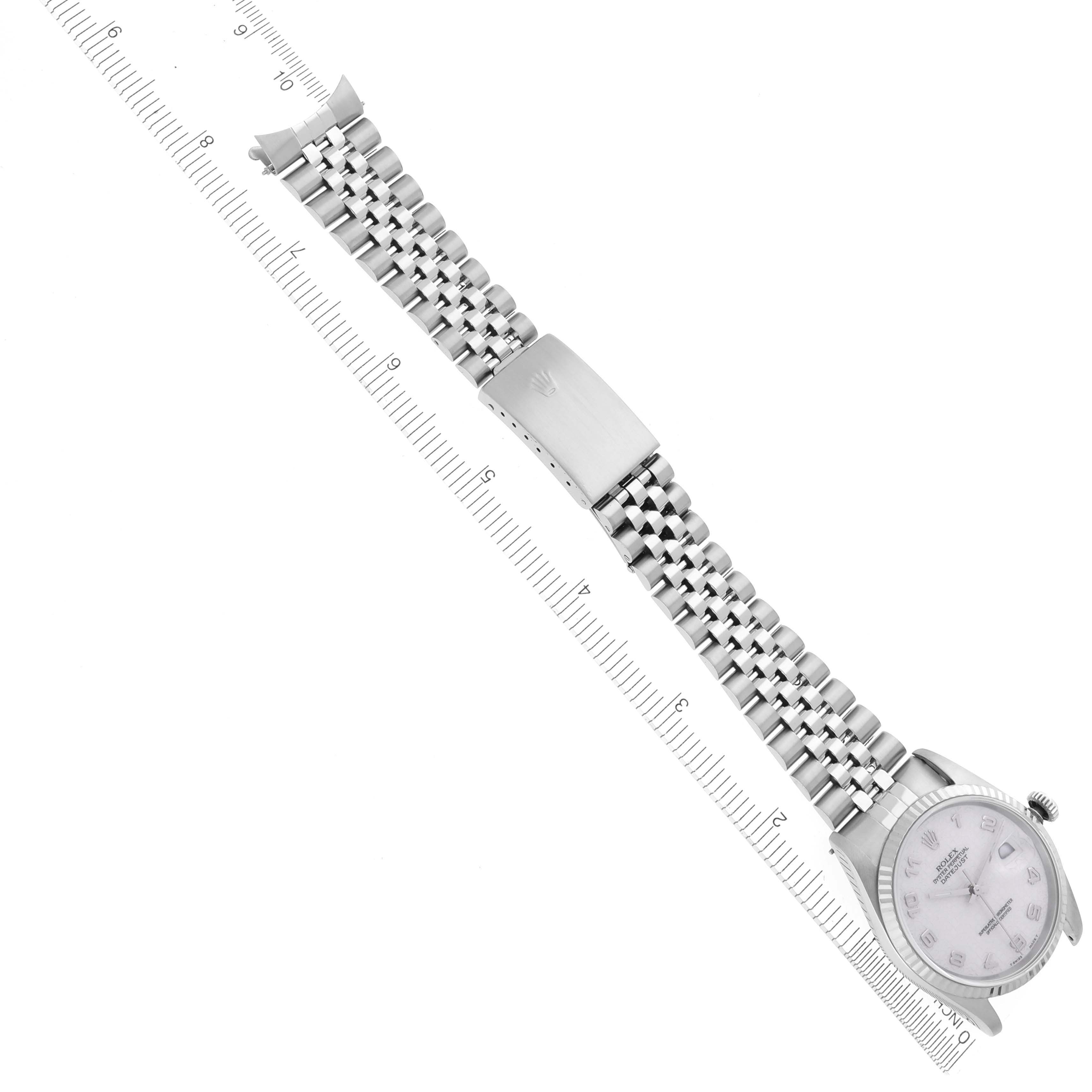 The Rolex Datejust 16234 Men's Stainless Steel Beige Dial 16234 Men's Stainless Steel Beige Dial watch is shown from a top-angle view, highlighting the bracelet and clasp alongside a measurement ruler.