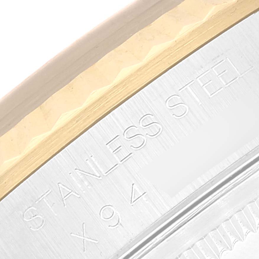 This close-up image of the Rolex Datejust 16233 Men's Steel and Gold (two tone) Black Dial 16233 Men's Steel and Gold (two tone) Black Dial watch shows part of the bezel and engraving on the case back.