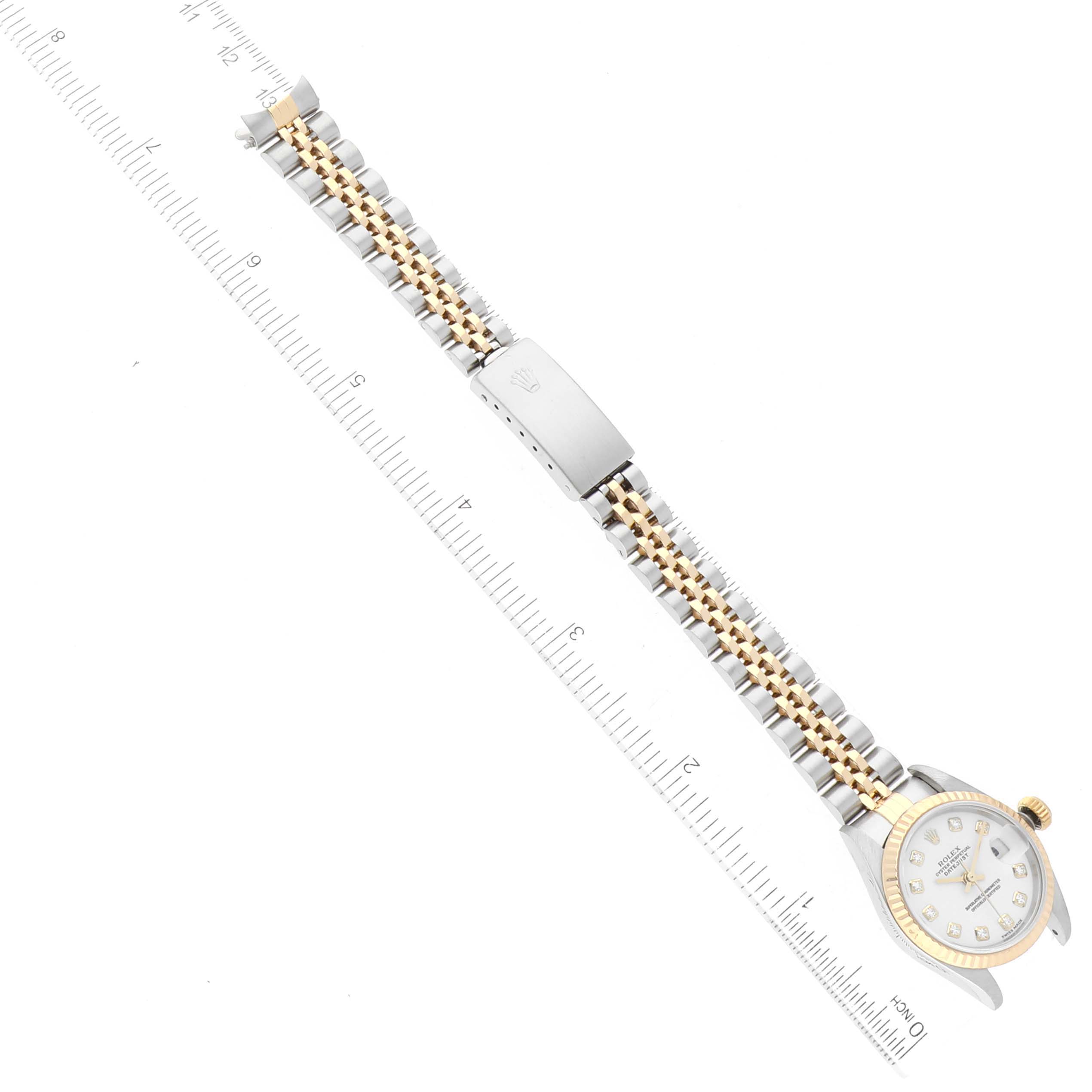The image shows a Rolex Datejust 79173 Women's Steel and Gold (two tone) White Dial 79173 Women's Steel and Gold (two tone) White Dial watch bracelet with the clasp and bezel visible, displayed alongside a ruler for measurement.