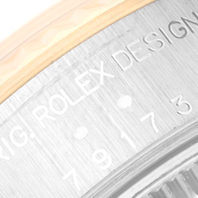 The image shows a close-up view of the side engraving on the bezel of a Rolex Datejust 79173 Women's Steel and Gold (two tone) White Dial 79173 Women's Steel and Gold (two tone) White Dial model watch.