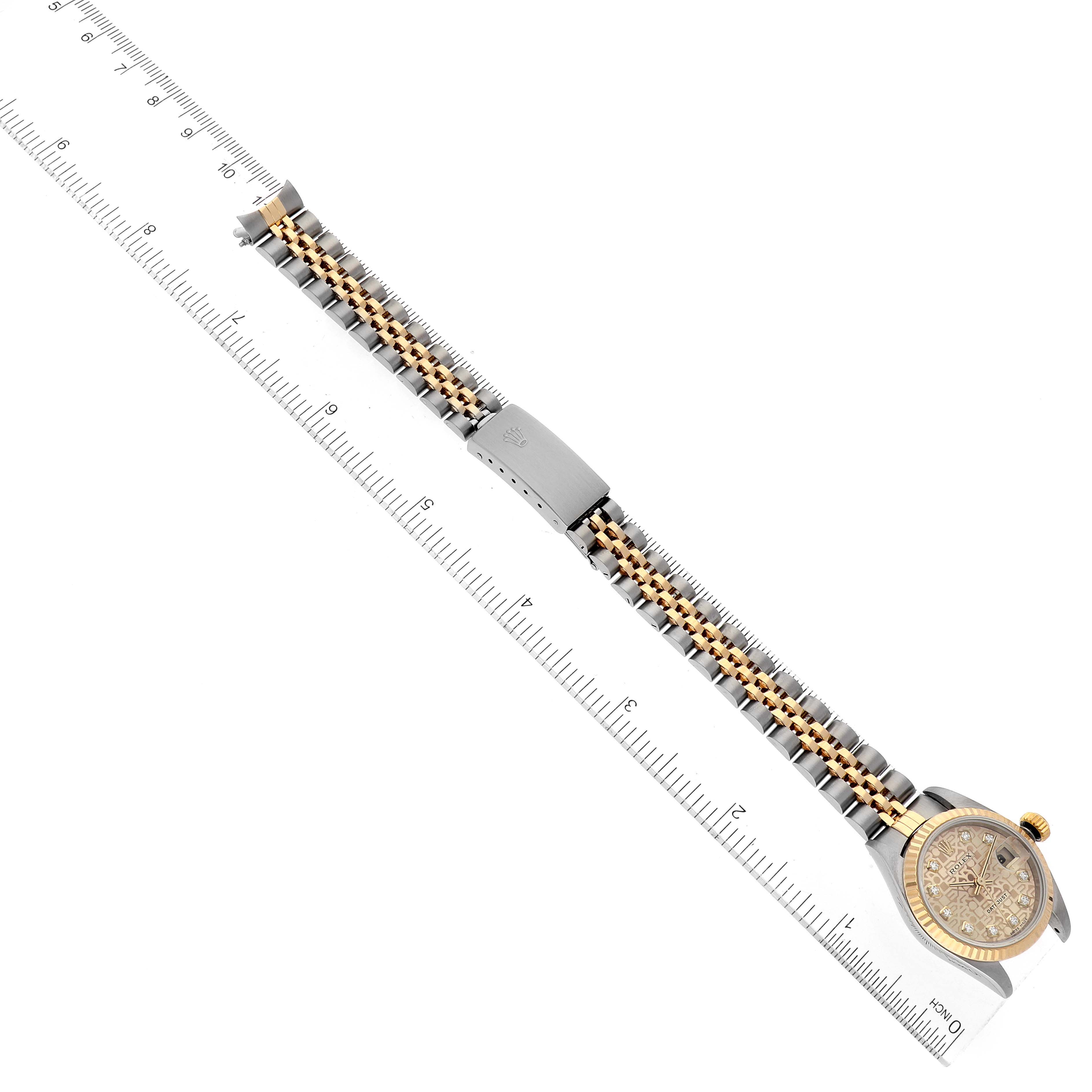 The image shows the entire Rolex Datejust 79173 Women's Steel and Gold (two tone) Champagne Dial 79173 Women's Steel and Gold (two tone) Champagne Dial watch from an overhead angle, alongside a ruler for scale.