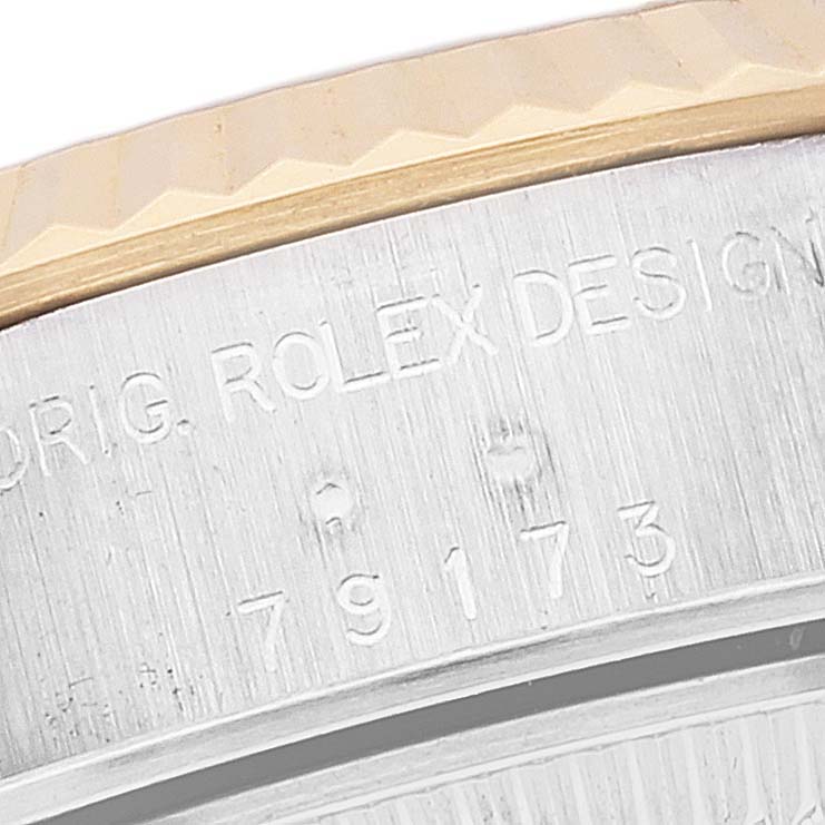This close-up image shows the engraved case back of a Rolex Datejust 79173 Women's Steel and Gold (two tone) Champagne Dial 79173 Women's Steel and Gold (two tone) Champagne Dial watch, featuring the model number and the fluted bezel.