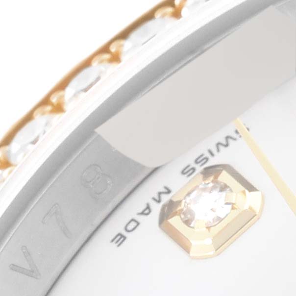 The image shows a close-up of the bezel, part of the dial, and a diamond-encrusted hour marker of a Rolex Datejust 116243 Men's Steel and Gold (two tone) White Dial 116243 Men's Steel and Gold (two tone) White Dial watch.