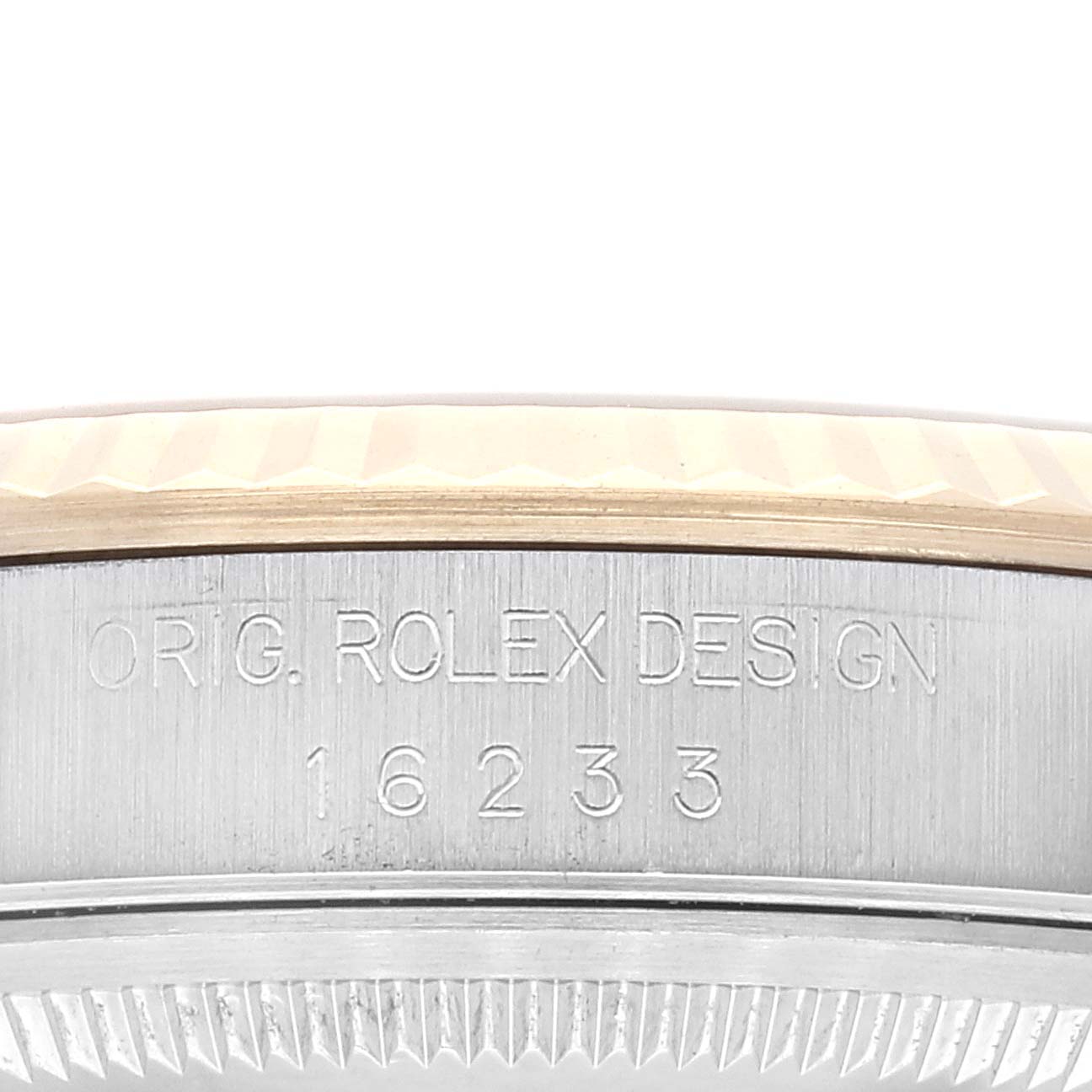 The image shows a close-up of the side case of a Rolex Datejust 16233 Men's Steel and Gold (two tone) Champagne Dial 16233 Men's Steel and Gold (two tone) Champagne Dial model, displaying the engraving "ORIG. ROLEX DESIGN 16233."