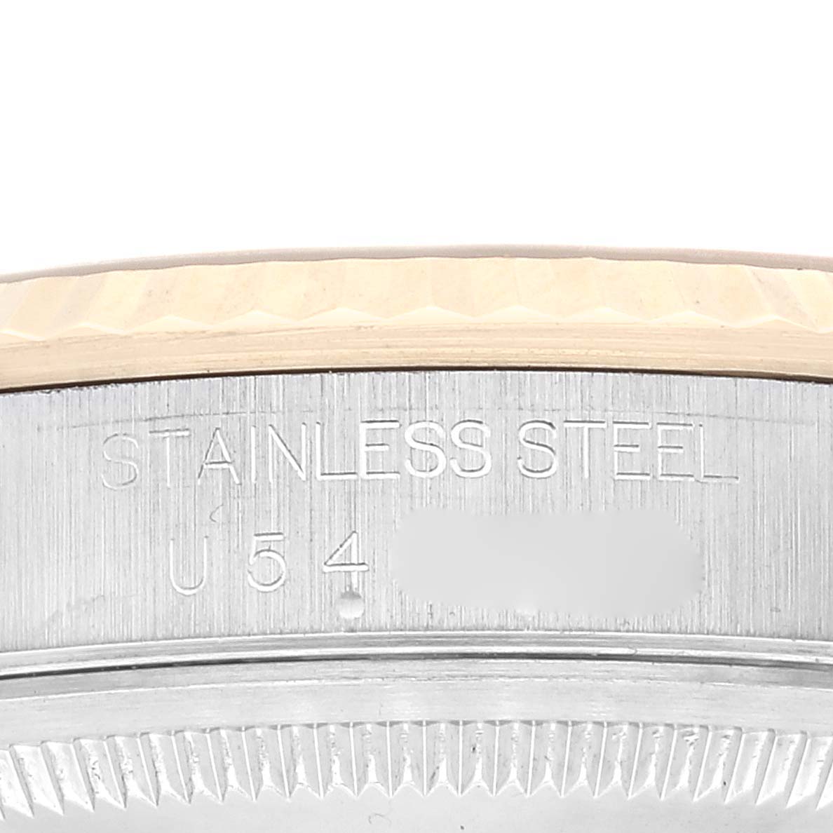This image shows a close-up of the side of the bezel and case of a Rolex Datejust 16233 Men's Steel and Gold (two tone) Champagne Dial 16233 Men's Steel and Gold (two tone) Champagne Dial, highlighting the "Stainless Steel" engraving.