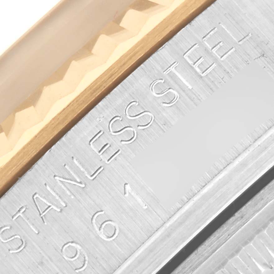 The image shows a close-up of the Rolex Datejust 16013 Men's Steel and Gold (two tone) Champagne Dial 16013 Men's Steel and Gold (two tone) Champagne Dial's bezel and engraved stainless steel inner ring.