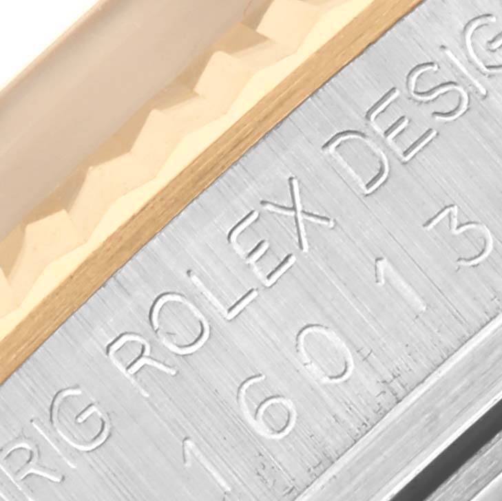 The image shows a close-up angle of the engraved side of a Rolex Datejust 16013 Men's Steel and Gold (two tone) Champagne Dial 16013 Men's Steel and Gold (two tone) Champagne Dial model, emphasizing the brand and design details.