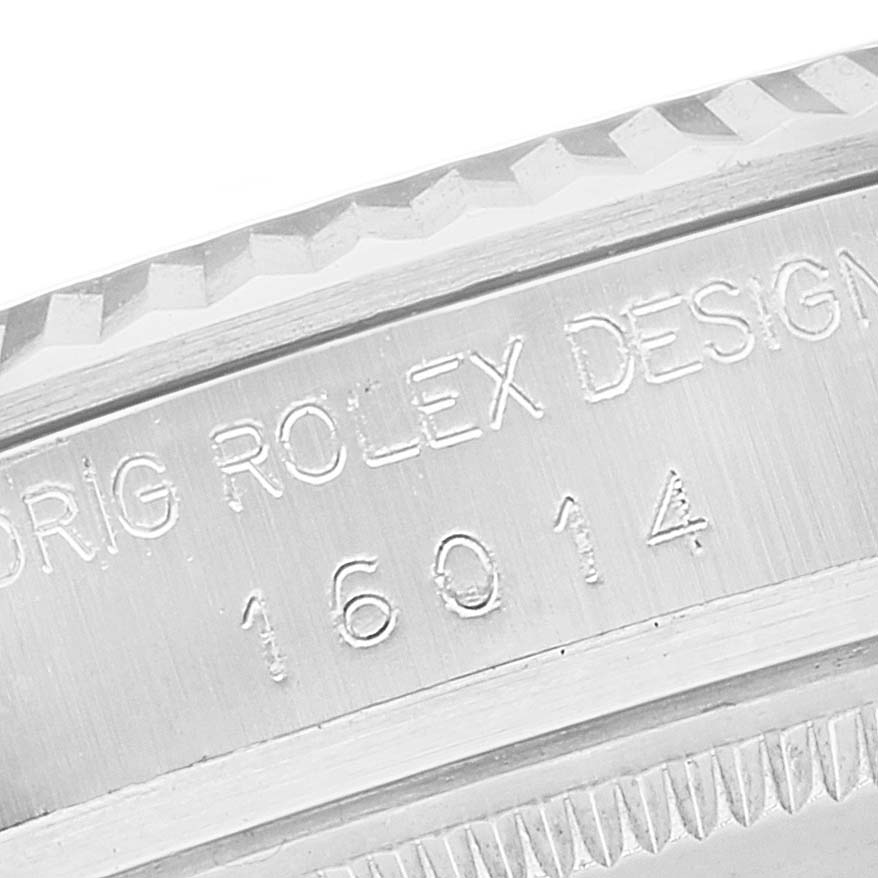 A close-up angle of the bezel and engraved case side of a Rolex Datejust 16014 Men's Stainless Steel Black Dial 16014 Men's Stainless Steel Black Dial model is shown.